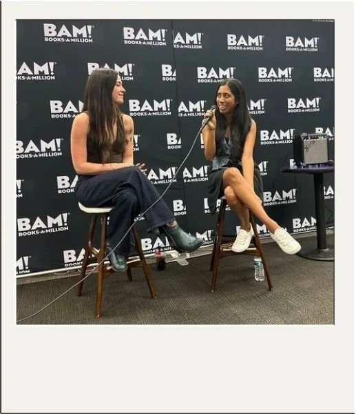 Two women sitting on stools at a BAM panel for authors