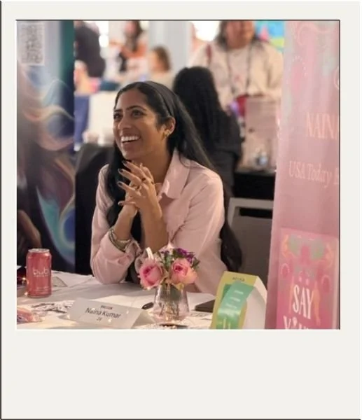 Author sitting at booth on a book tour