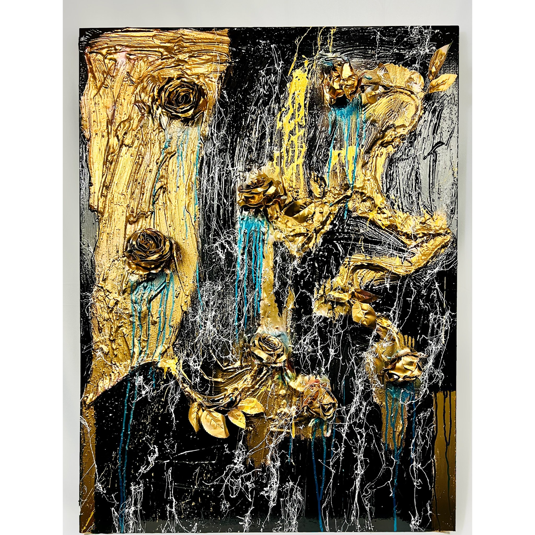 Abstract painting with gold roses and textured black, white, yellow, and blue paint splatters.
