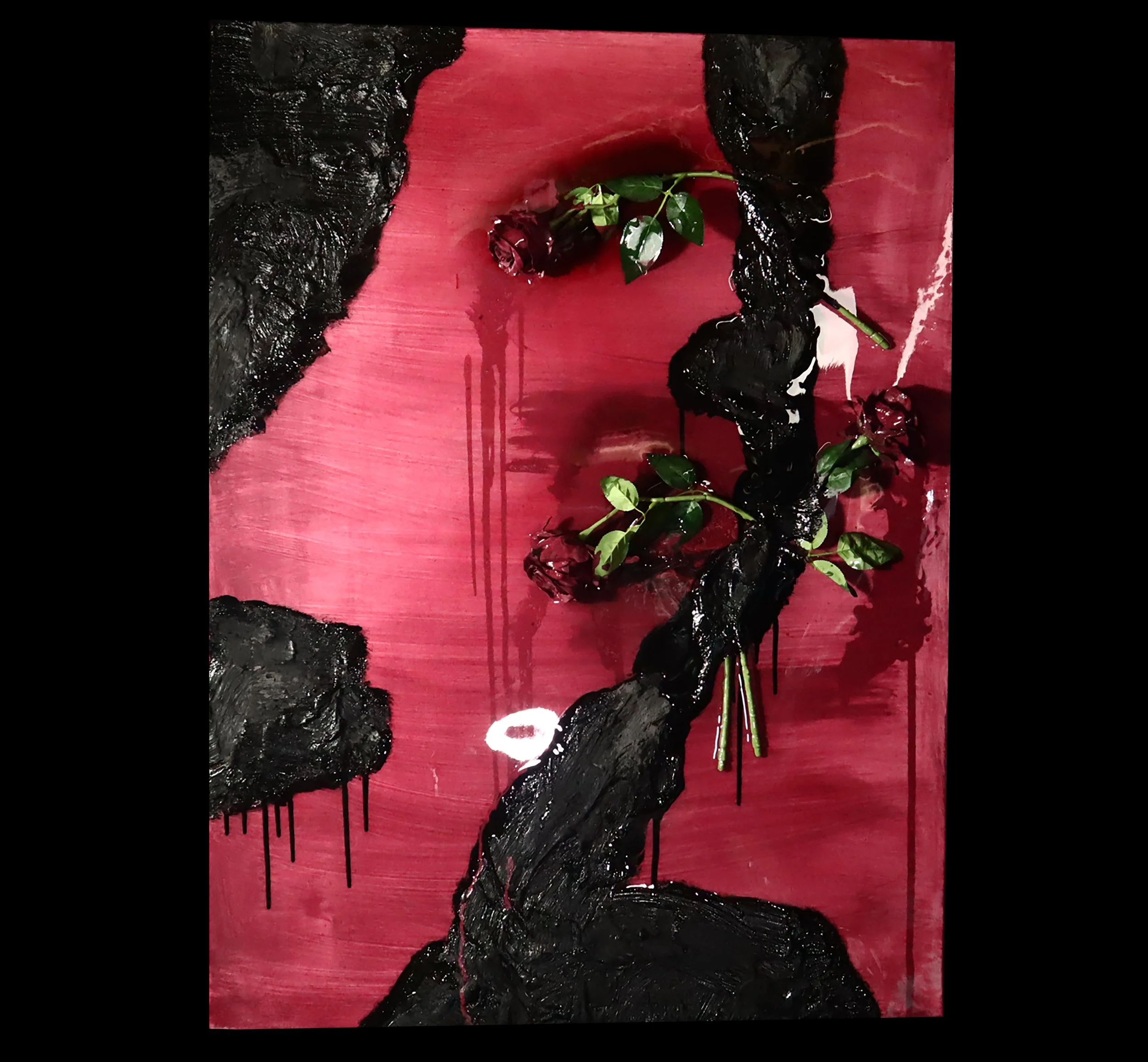 Abstract artwork with a red background, black textured formations, and three red roses with green leaves.