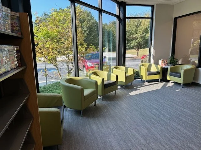 rphoto of reading area in the library with green chairs