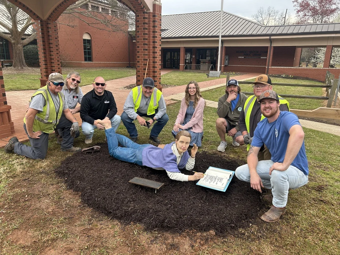 Statue reading in front of the library