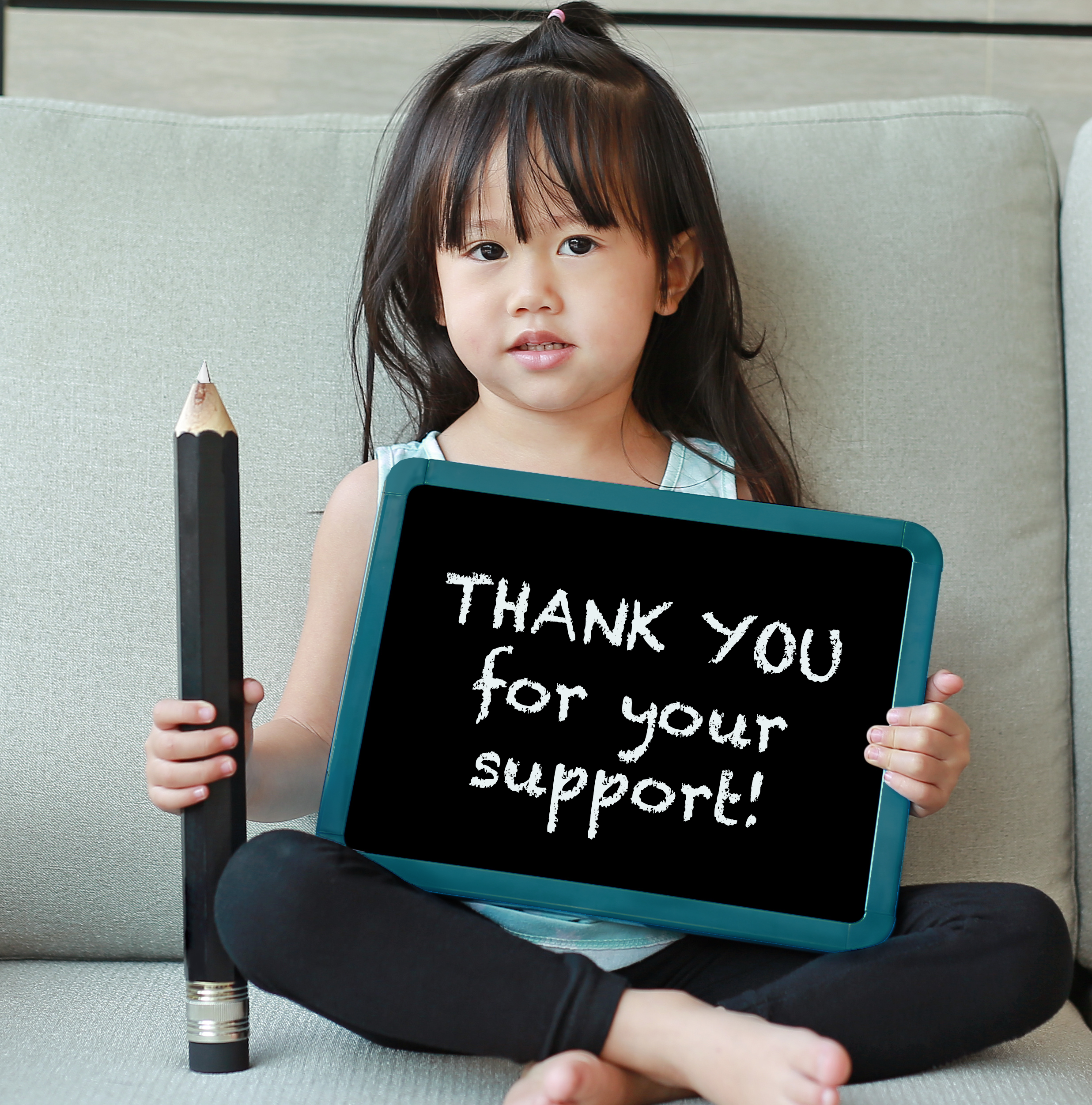 holiday hampers footer girl with chalkboard saying thank you for your support