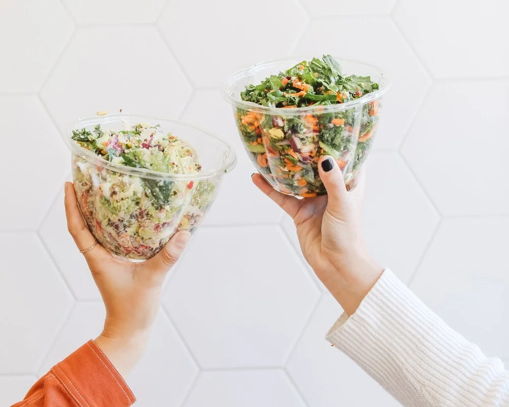 hands holding salad bowl
