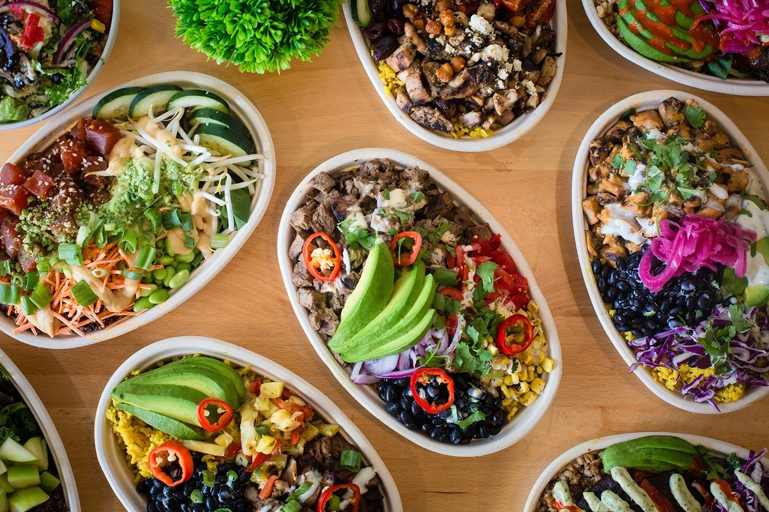 Table of individual bowls of salads.