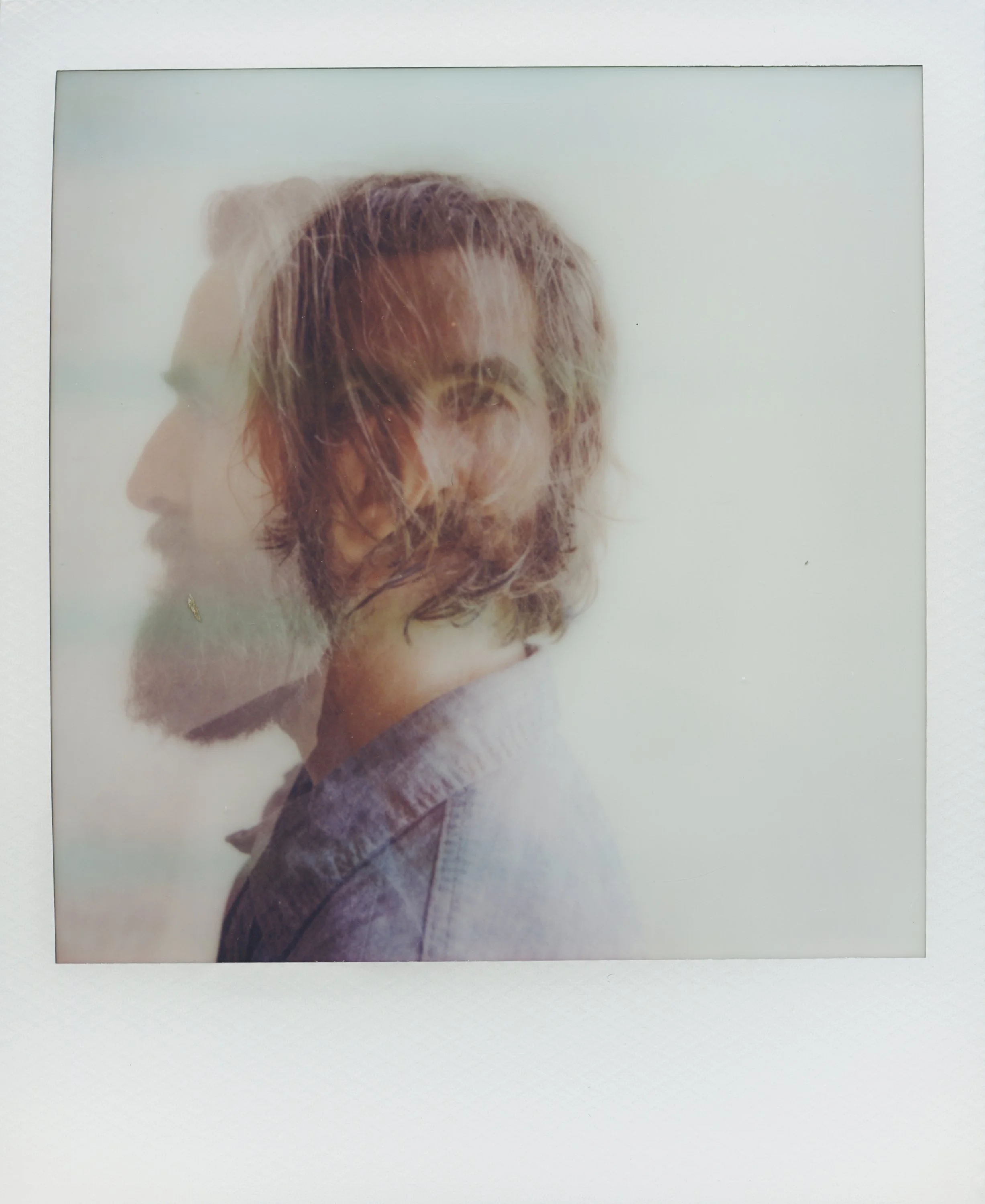 Polaroid instant portrait of musicians Tyler Ramsey and Carl Broemel sitting together on wooden stairs, captured for their collaborative album Celestin by Parker J. Pfister.