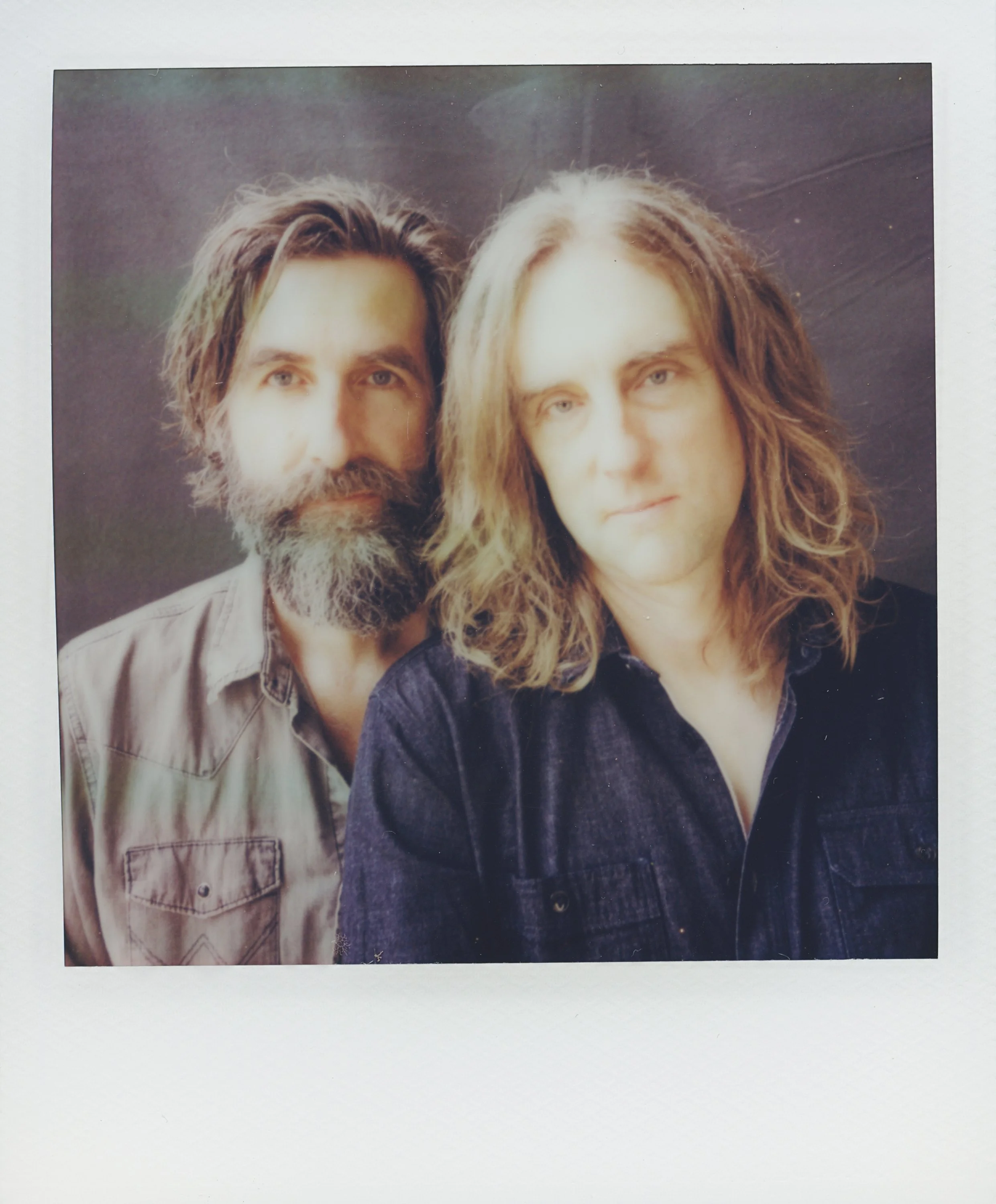 Polaroid portrait of musicians Tyler Ramsey and Carl Broemel standing together, captured for their collaborative album Celestin by Parker J. Pfister.