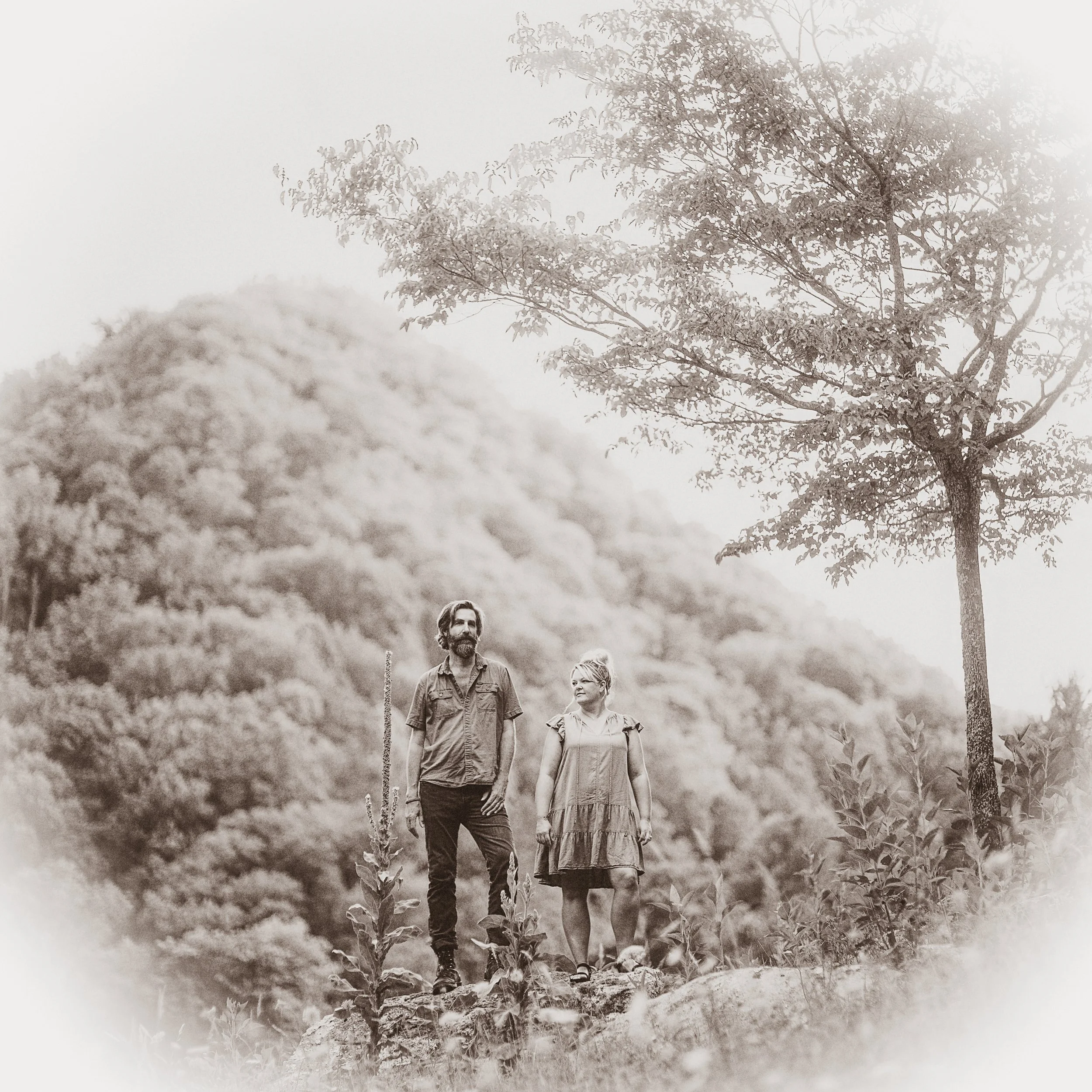 Infrared-style fine art portrait of musicians Tyler Ramsey and Donna Ray Norton standing on a hillside in Madison County, NC for their album of traditional Appalachian ballads recorded at Rare Bird Farm, photographed by Parker J. Pfister.