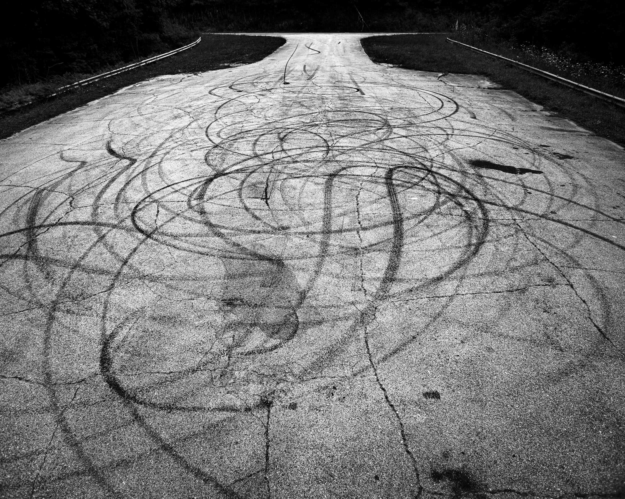 Parker J Pfister Fine Art Man & Land Black and White series of wheelie marks covering a section of road.