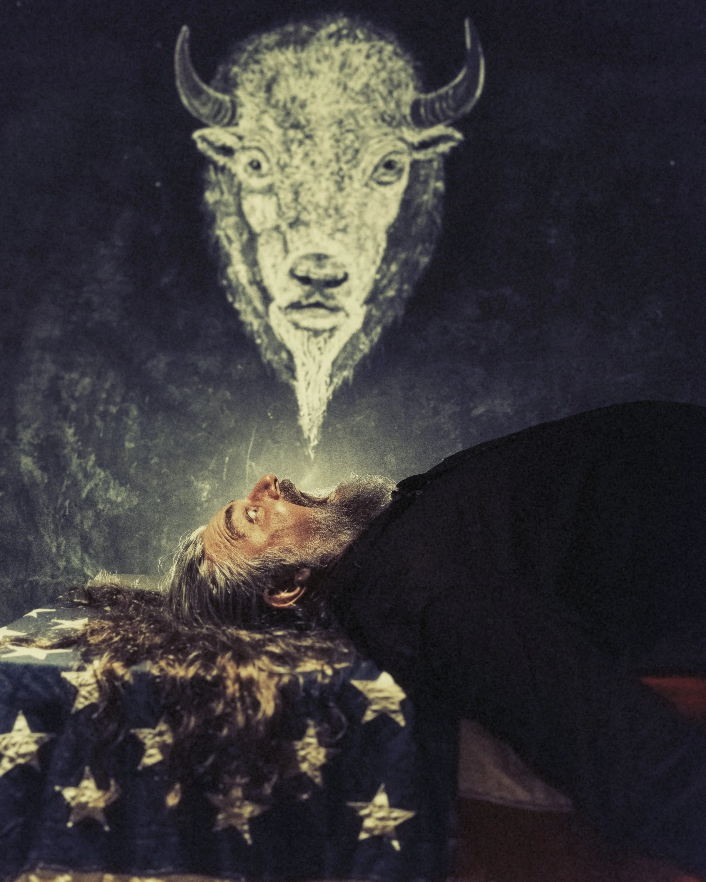 Here is a tailored description for that studio portrait of Jake Smith (The White Buffalo), ready to paste into the DESCRIPTION field:

Fine art portrait of musician Jake Smith, known as The White Buffalo, lying beneath a hand-painted buffalo tapestry