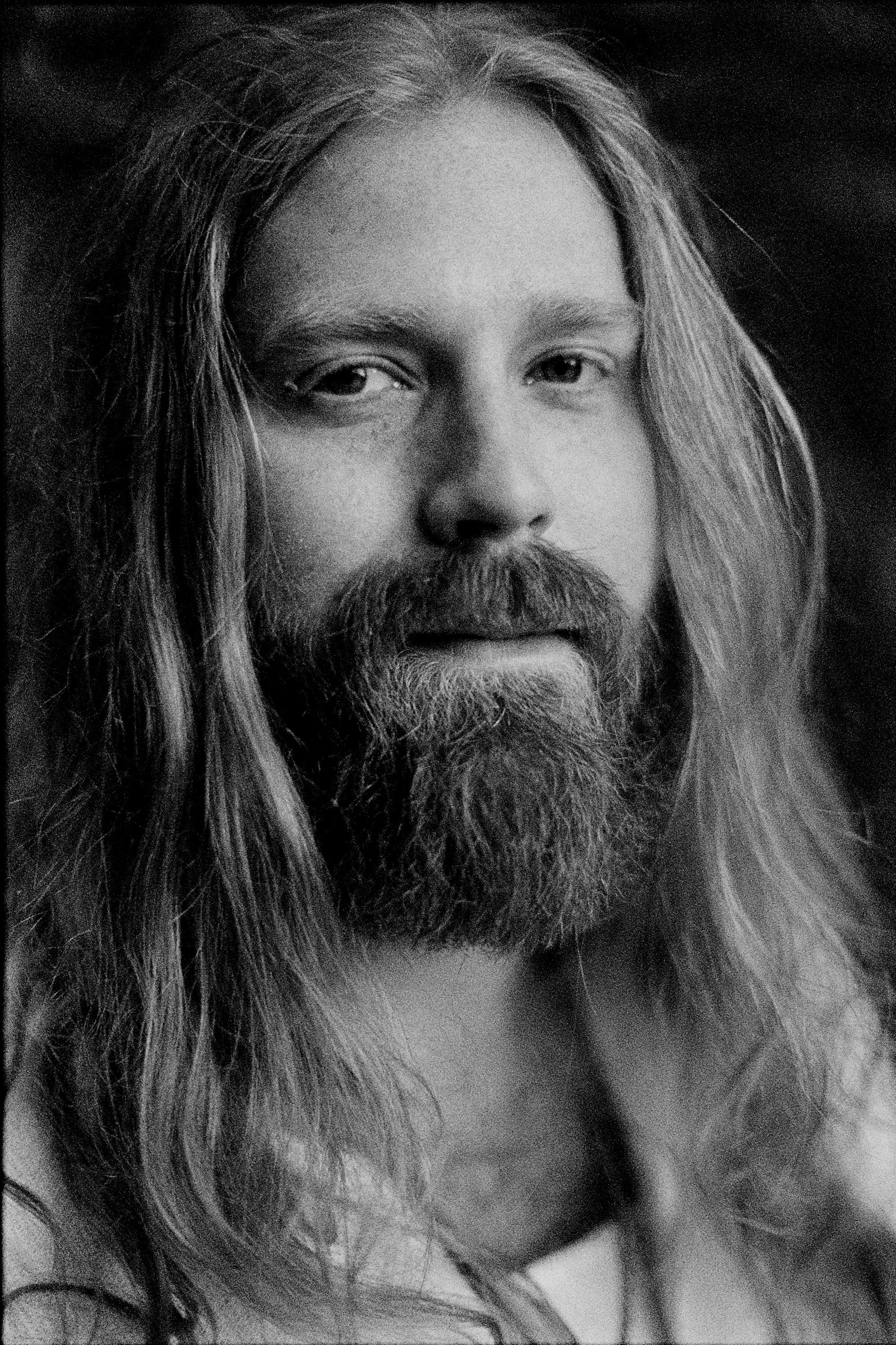 Black and white portrait of country music artist Mitchell Ferguson with long hair and beard, captured on 35mm film by Parker J. Pfister.

