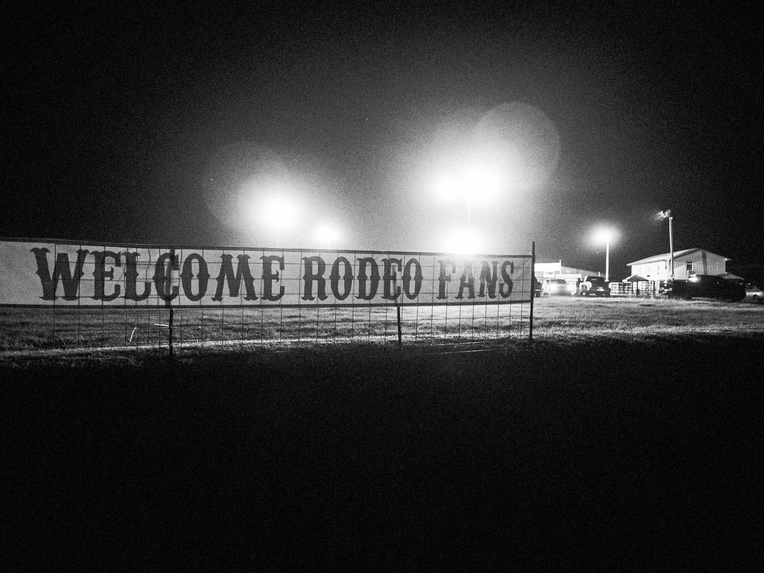 A high-contrast black and white portrait capturing the raw emotion and weathered character of a subject at a rodeo in Madison County, North Carolina.
