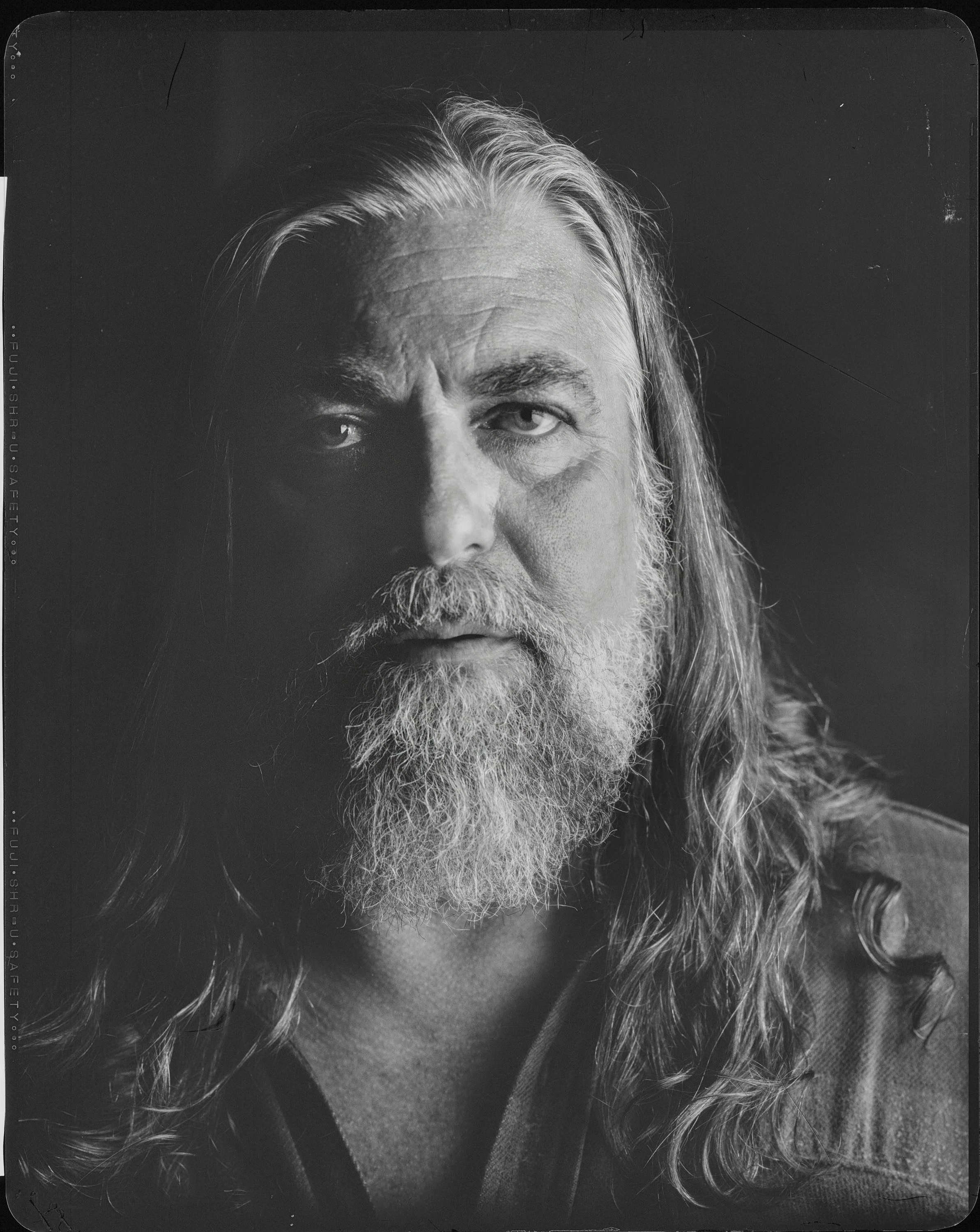 Black and white fine art portrait of musician Jake Smith, known as The White Buffalo, with long hair and beard, captured on 8x10 X-ray film by Parker J. Pfister.