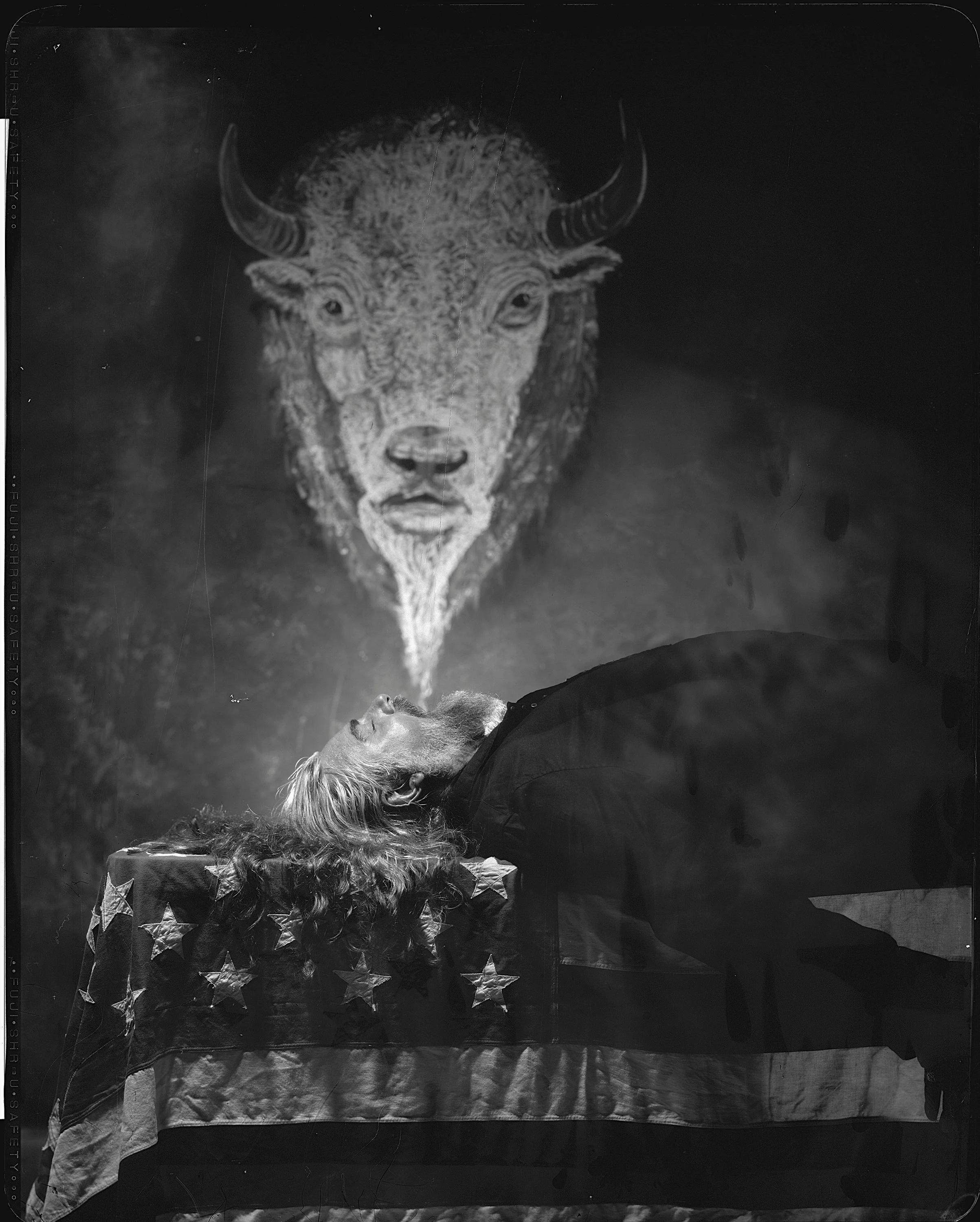 Fine art portrait of musician Jake Smith, known as The White Buffalo, framed beneath a hand-drawn buffalo tapestry in a custom studio set, captured on 8x10 x-ray film by Parker J. Pfister.
