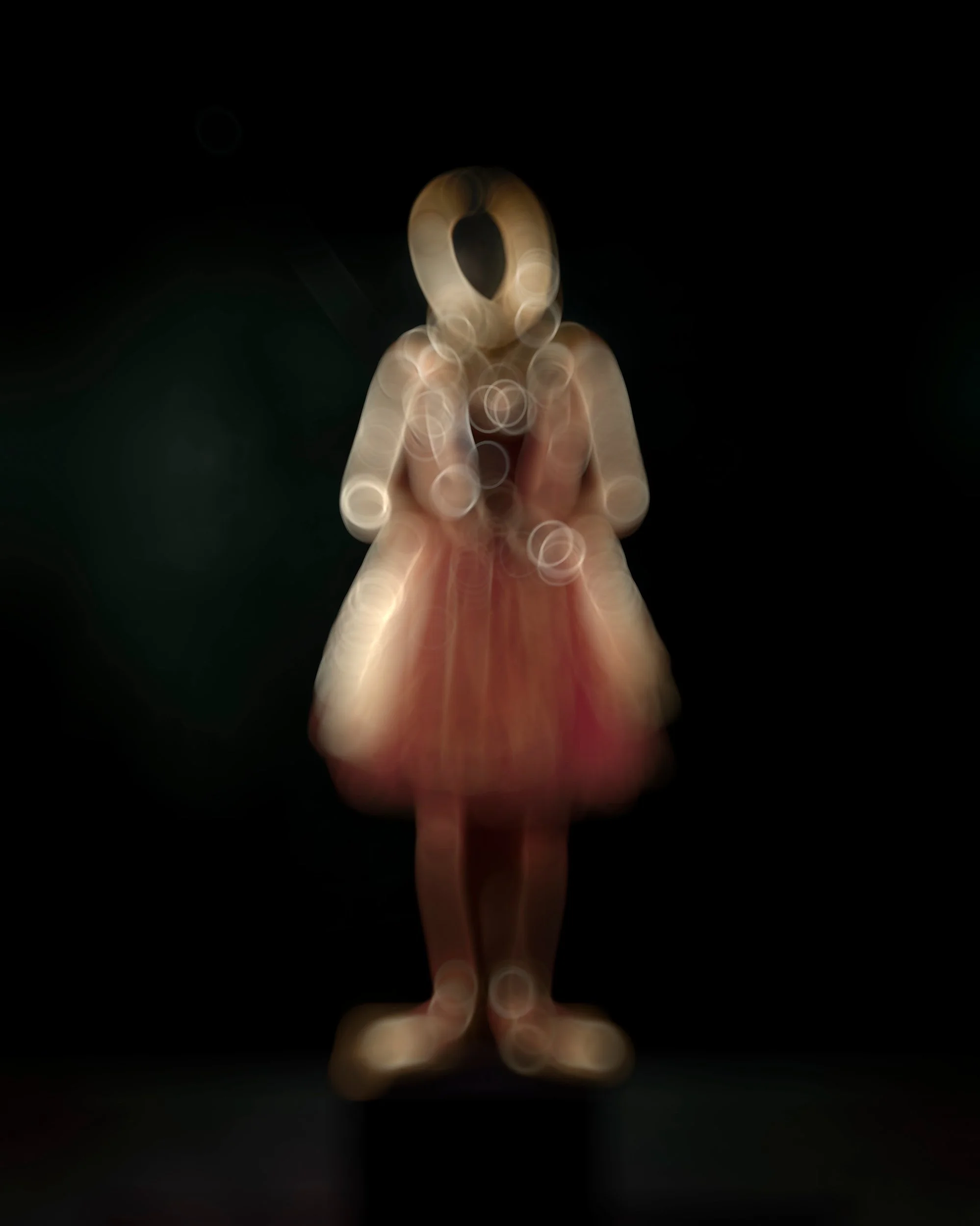 An intentional out of focus fine art portrait captured using a vintage lens and an oil-coated filter, creating soft, painterly light leaks and abstract textures.