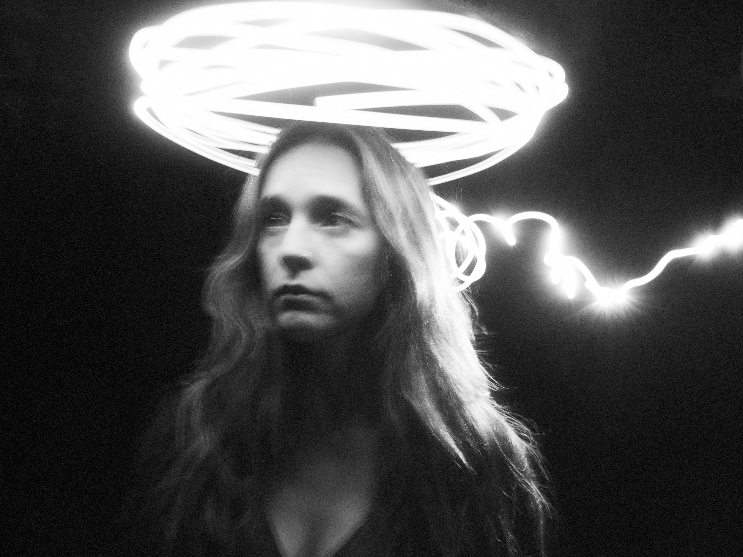 Here is the updated description incorporating the album title, ready to paste into the DESCRIPTION field:

Black and white portrait of musician Lindsay Wall of Blue Ridge Betty featuring long exposure light painting halo effects, captured for their a