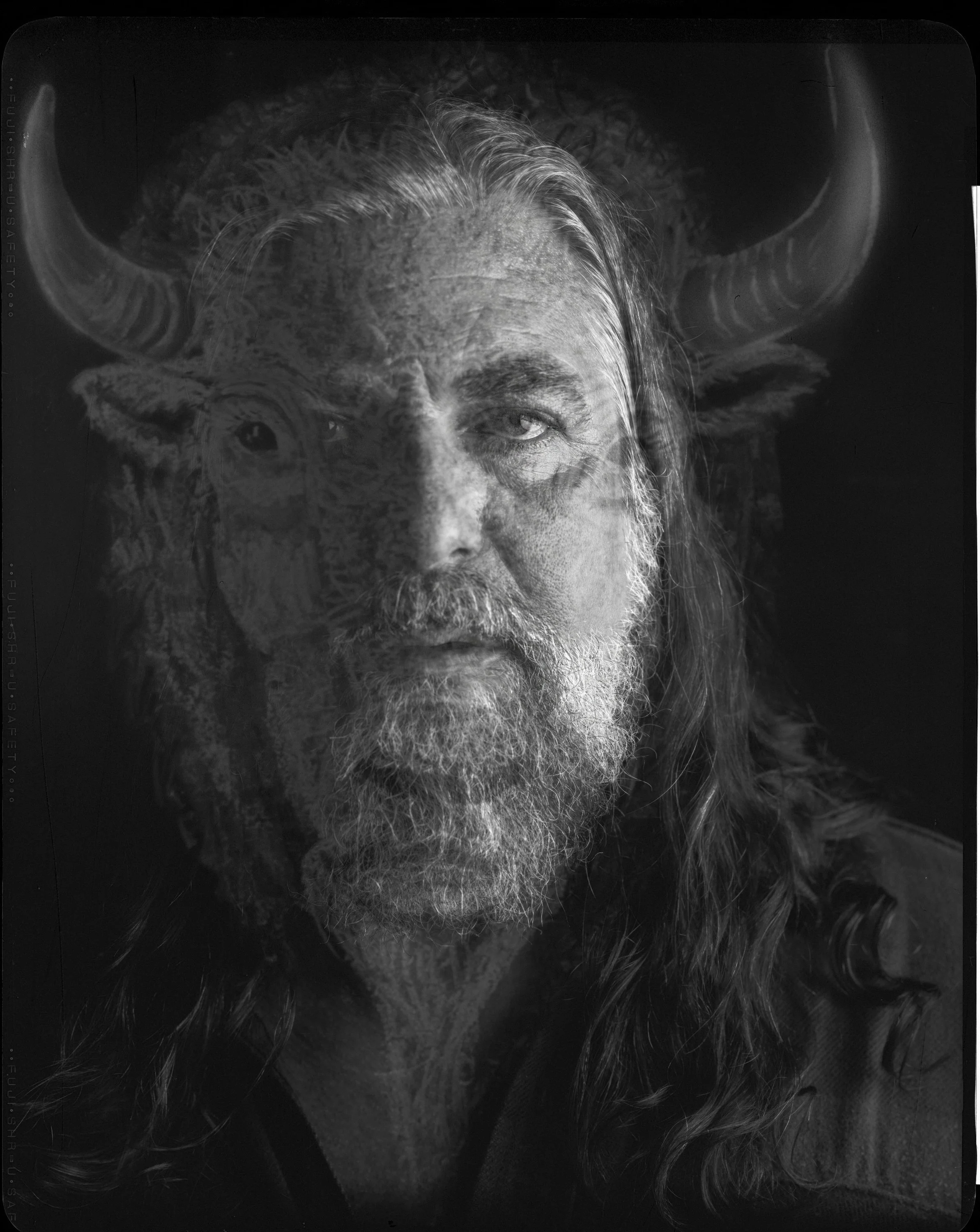Fine art double-exposure portrait of musician Jake Smith, known as The White Buffalo, combining his likeness with a custom studio wall drawing of buffalo horns, captured on 8x10 X-ray film by Parker J. Pfister.