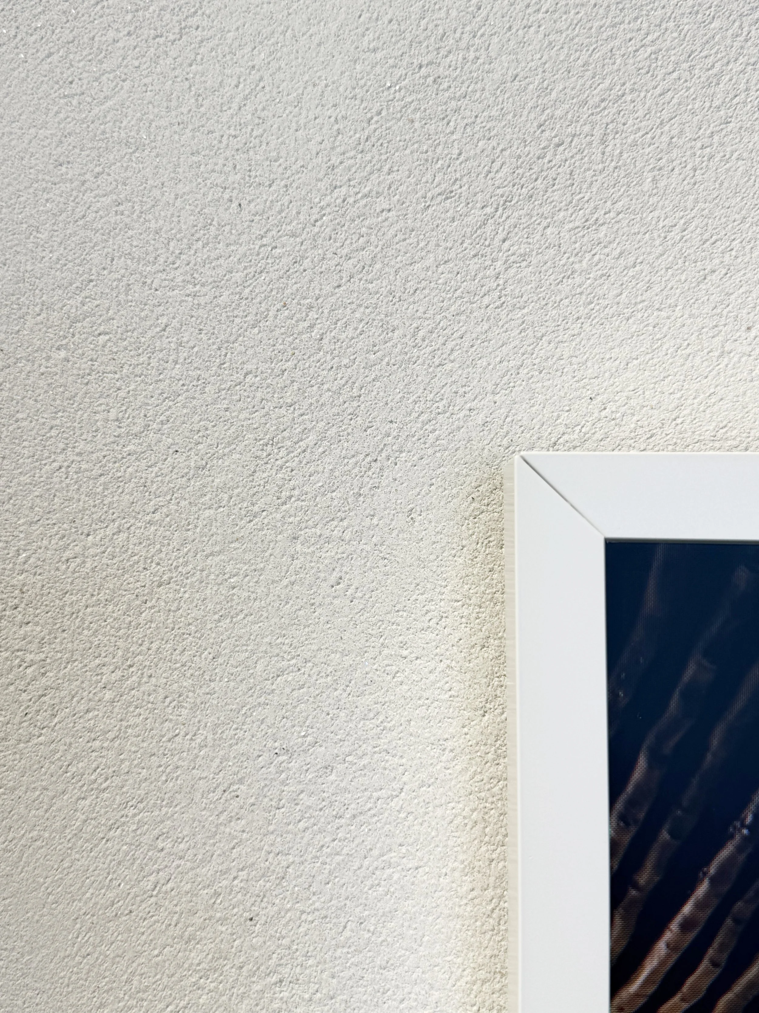 Grainy course white texture clay plaster surface with tv