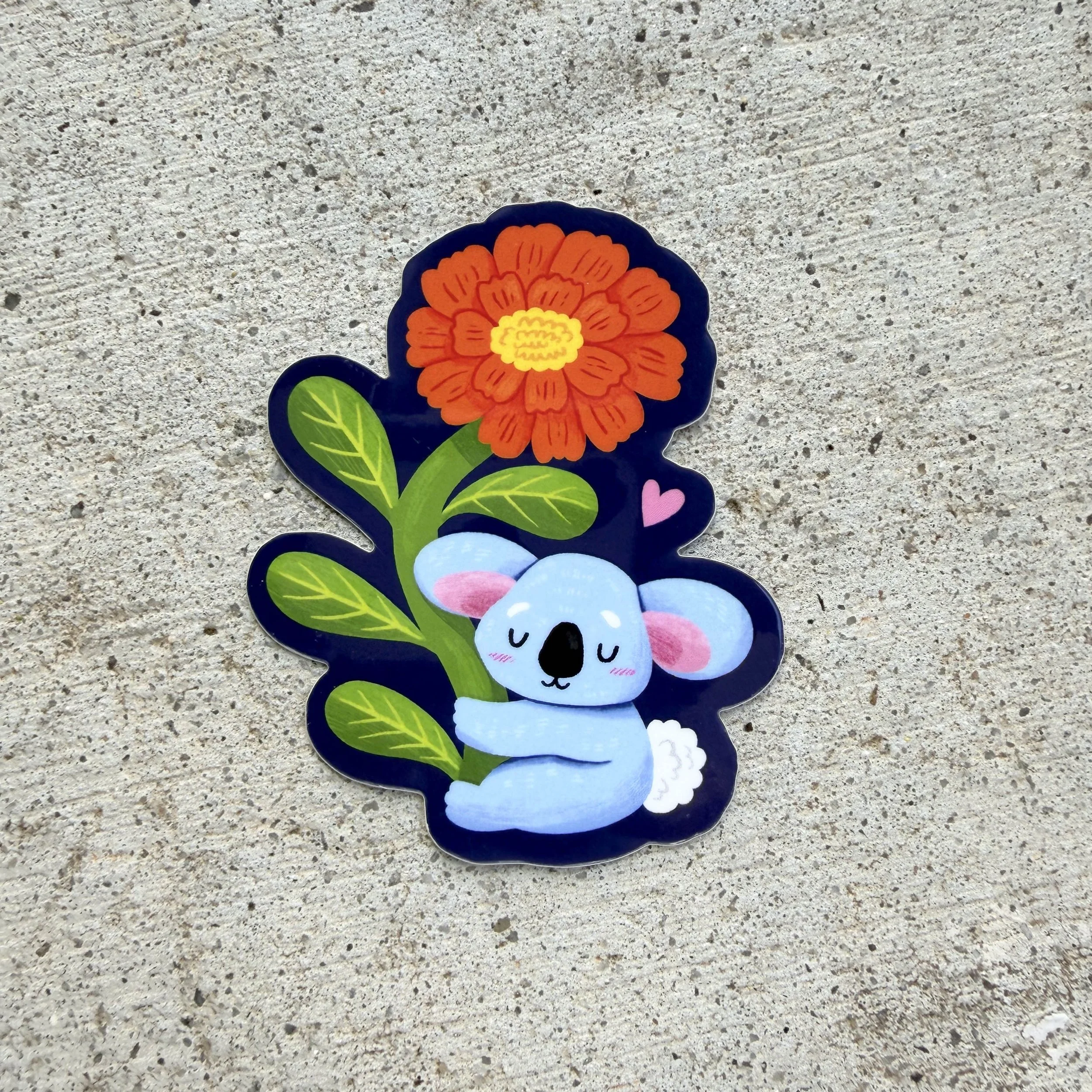 Komala Holding A Flower Sticker