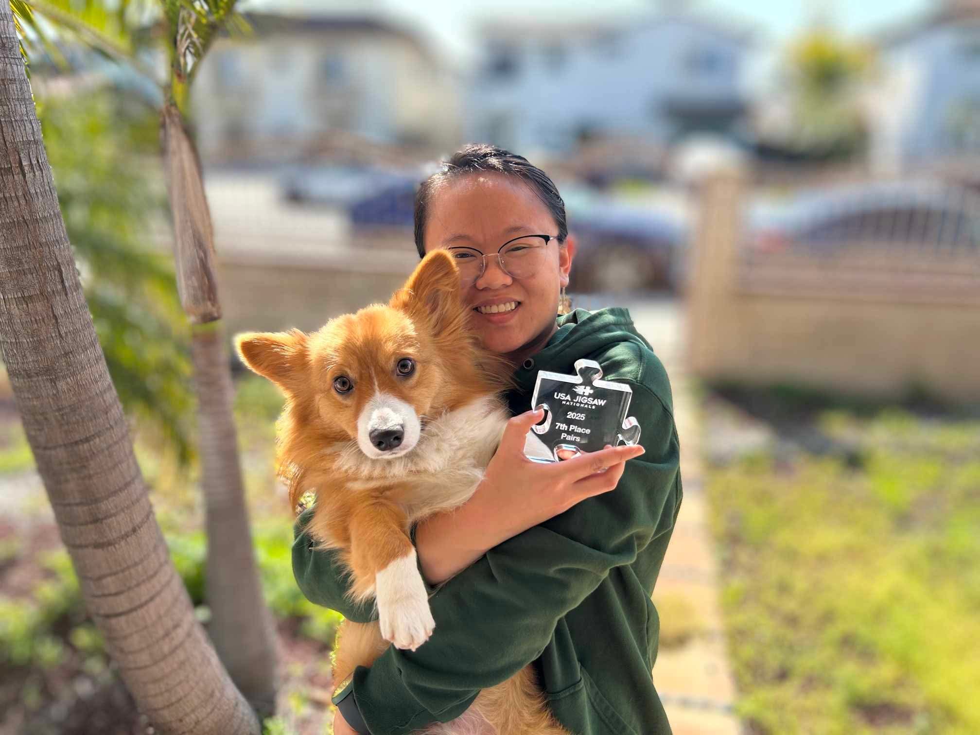 Yoshi and Min reunited after the 2025 USA Jigsaw Nationals. Min reports that Yoshi was unimpressed with being presented a 7th Place Pairs trophy, as it was inedible.