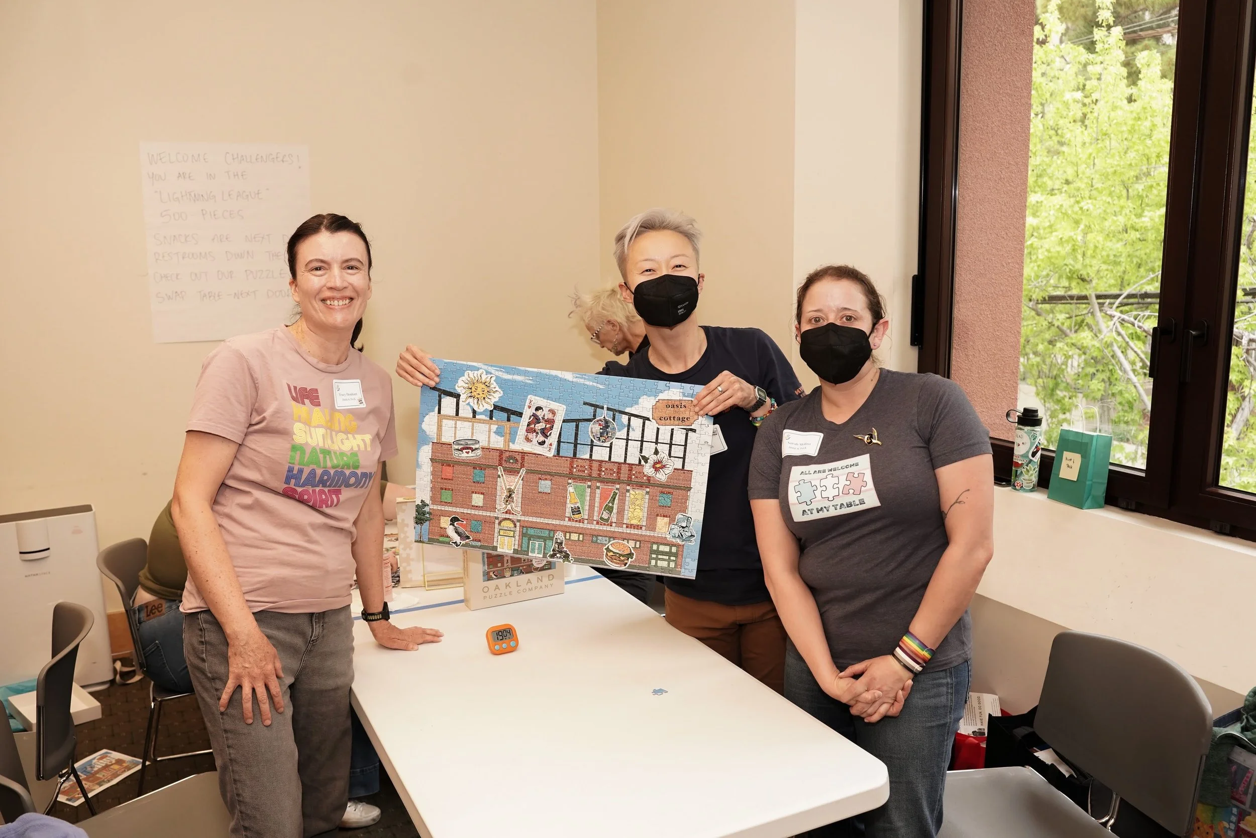 Feifei fundraising for Oasis Legal Services and winning their Puzzle Palooza 2026 with Tracy H. and Norah M.