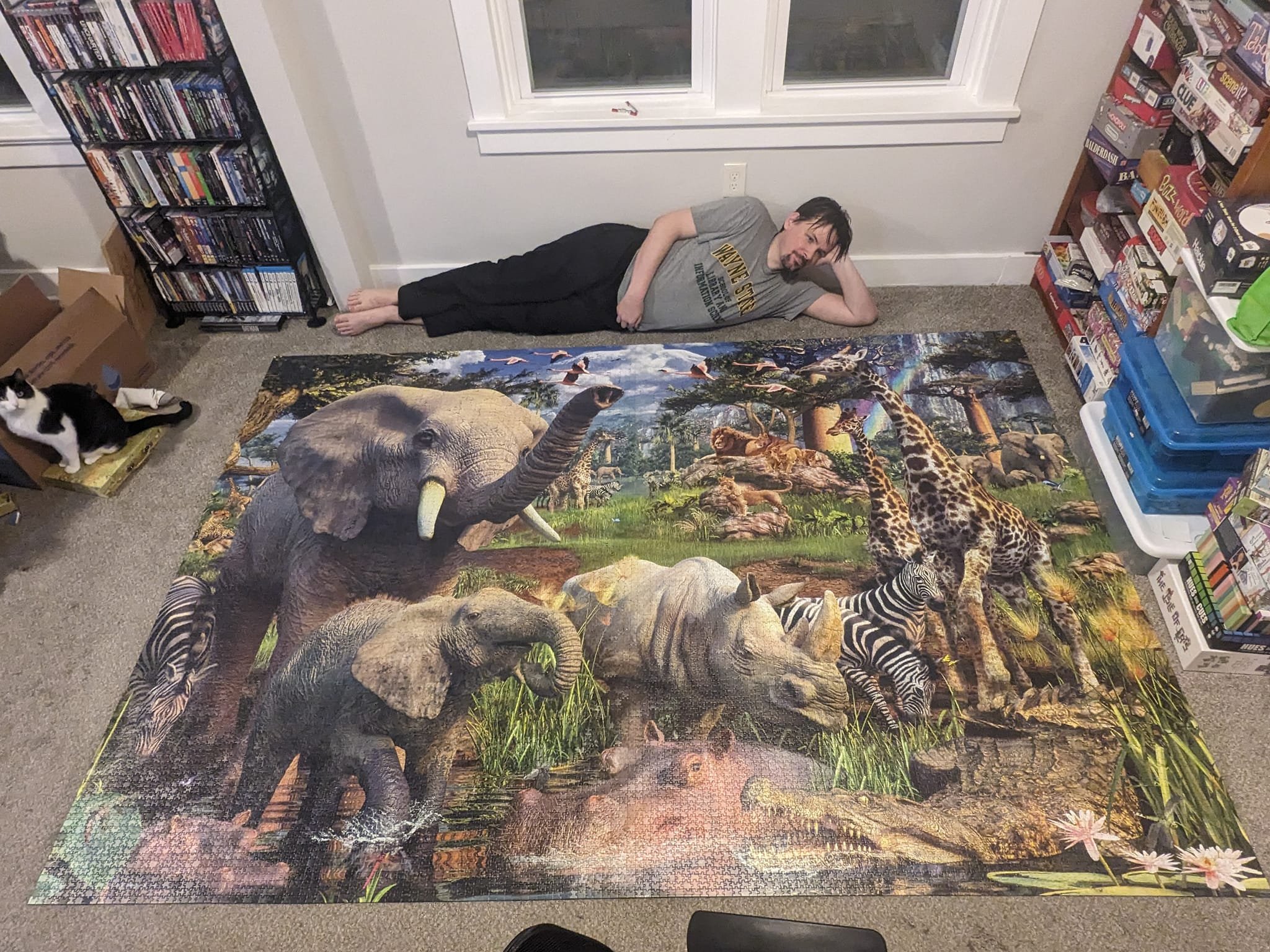 Kevin poses with the largest puzzle he has completed: An 18,000-piece Ravensburger