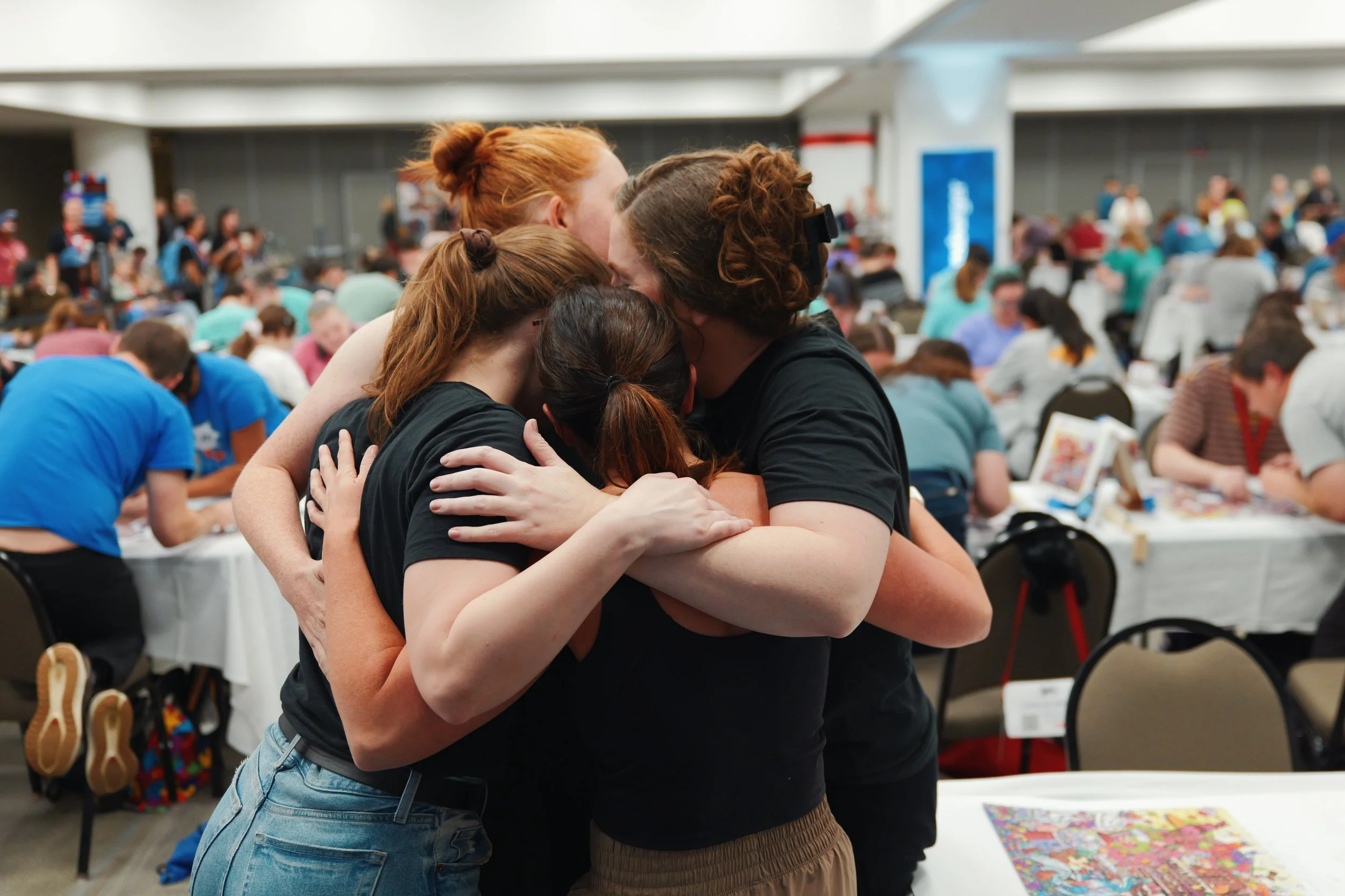 A big hug after the Jiggernauts won the 2026 USA Jigsaw National Team Championship
