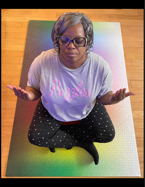 Gma sitting atop her first solo 5000-piece puzzle, completed on her Twitch stream