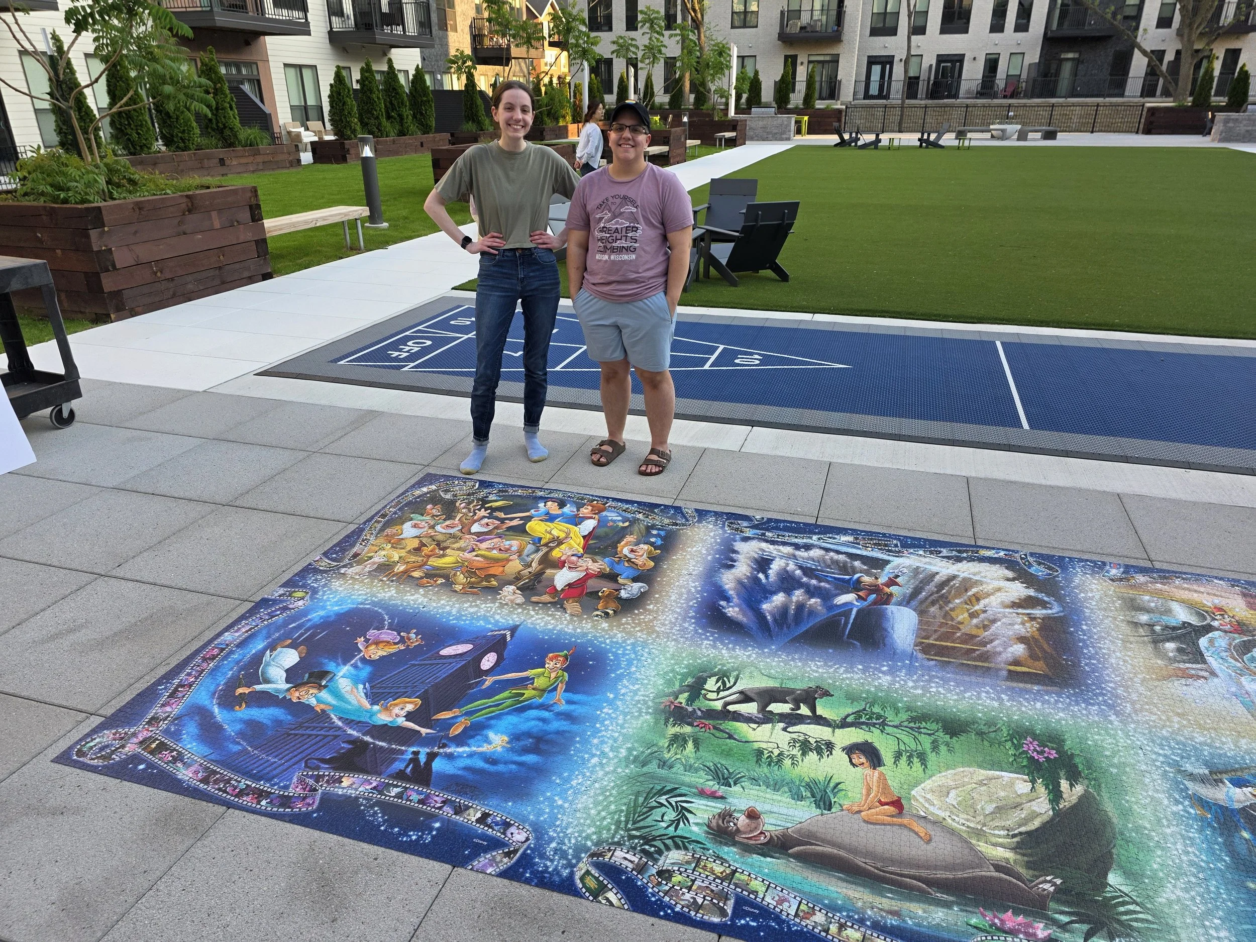 Dakota and Hanna S. pictured with the Ravensburger 40,320-piece Memorable Disney Moments puzzle. Dakota only got to help complete the Snow White section of this puzzle but had a blast!