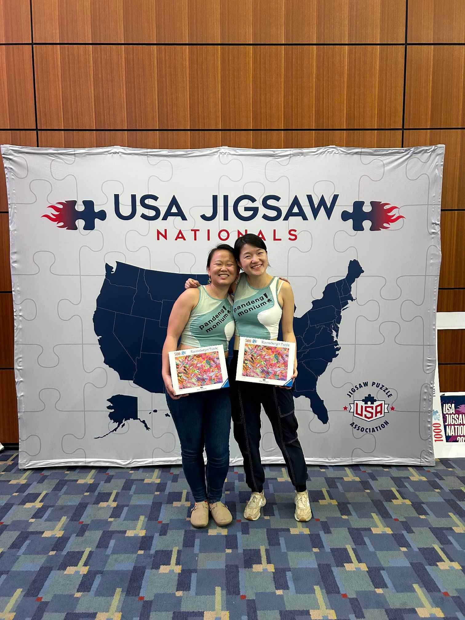 Min D. and Emma P. at the 2025 USA Jigsaw Nationals, wearing matching tiny shirts and celebrating their 7th place finish in the Pairs Final!