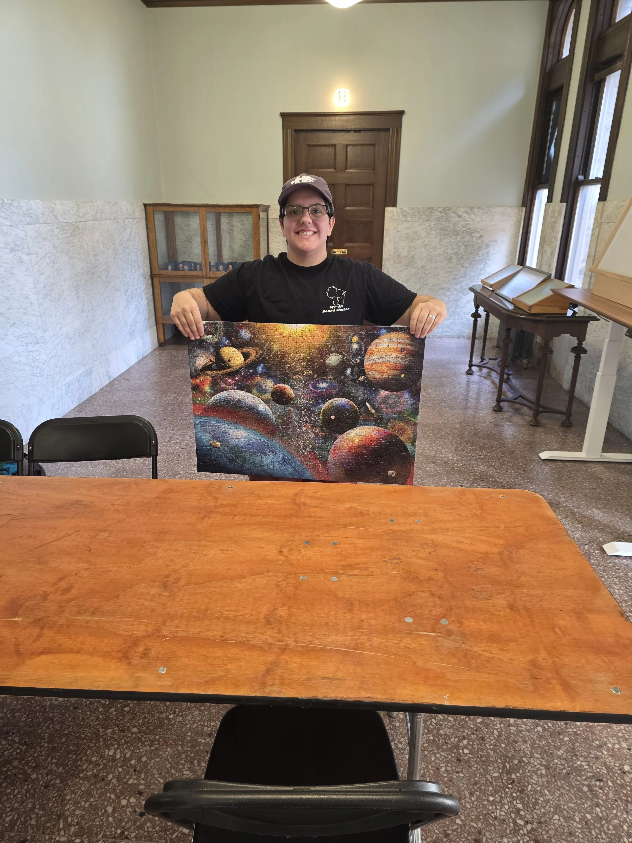 Dakota holding up the final puzzle from the Prairie Lakes Puzzle Tournament. This tournament included three rounds of puzzling: a 500-piece round, a 750-piece round, and a 1000-piece round!