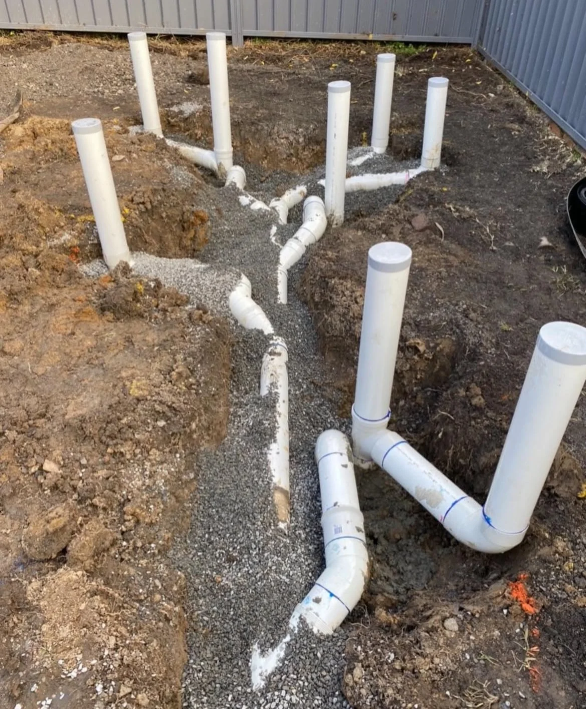 Underground plumbing pipes installation for a building.