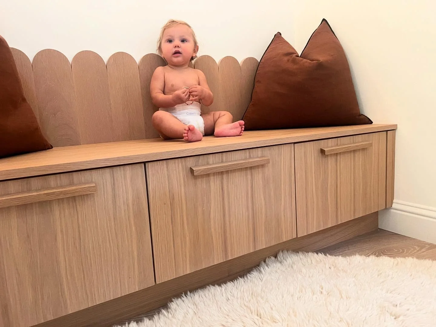 Built in white oak, scallop edge bench seat in Lafayette home. Occupied by one happy little baby and designed in collaboration with homeowner @alexisannesahi