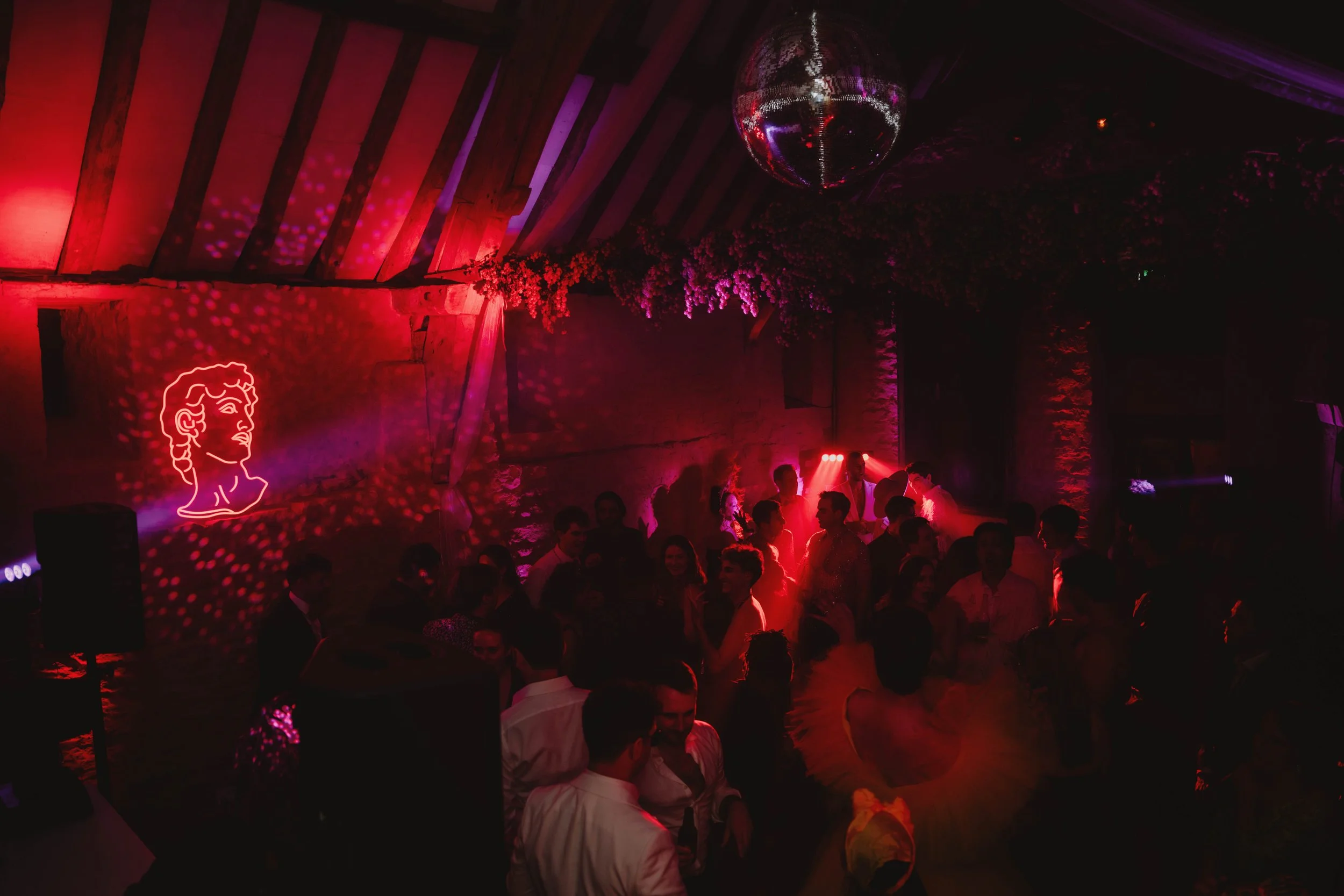 Indoor party scene with neon artwork and disco lights