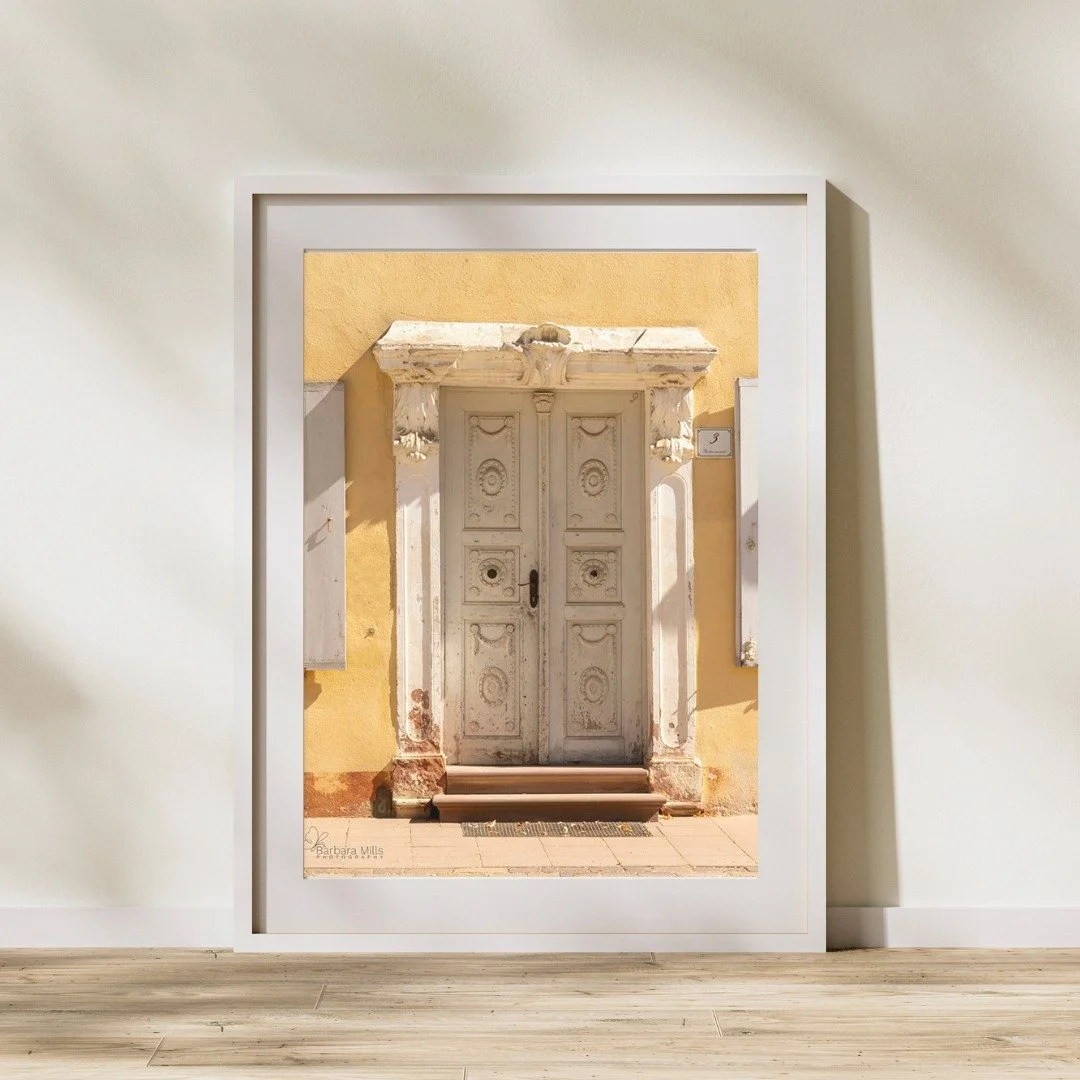 For February, we feature Wilhelmsbad Door, captured on a bright summer day in Germany. Though local in location, the warm sunlight and textured surfaces hint at distant lands and quiet stories waiting beyond the threshold.

The door invites reflectio