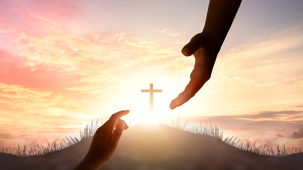 Cross at sunrise representing God’s grace, faith, and salvation in Lutheran Christian beliefs.