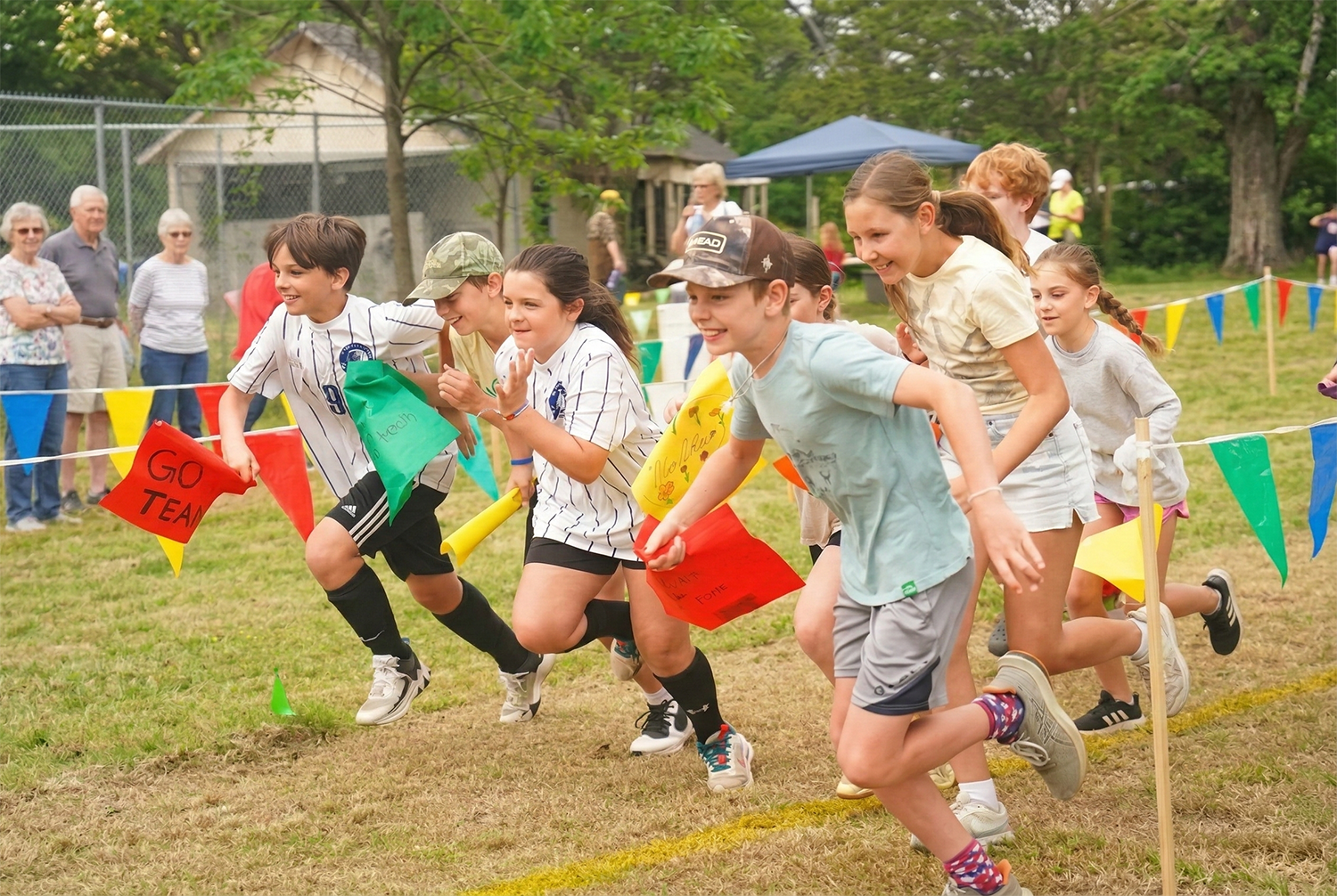 Children running in a relay race during a church community event at Christ Little Rock