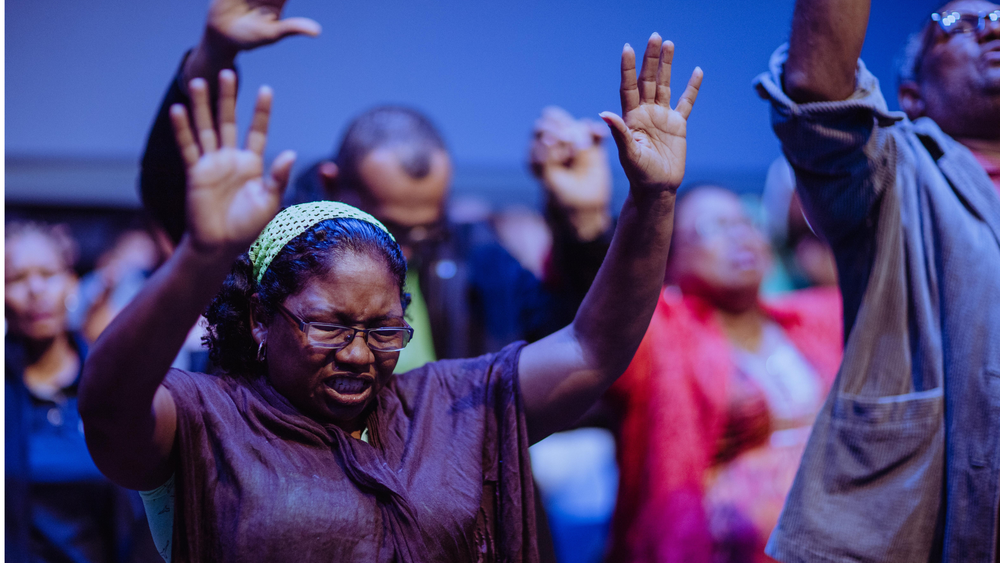 Lutheran congregation worshiping together with prayer and praise at Christ Little Rock Church.