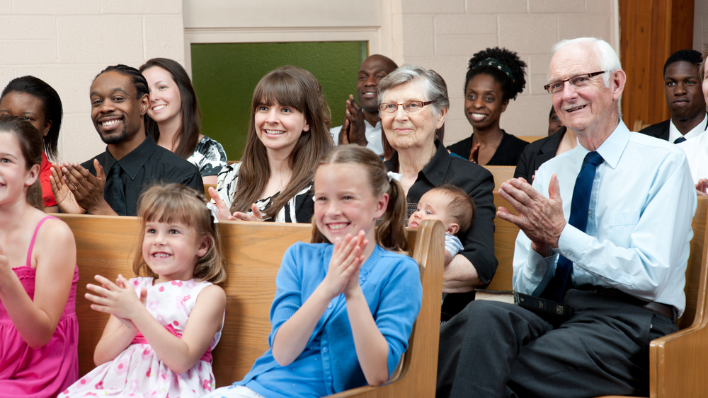 Diverse church members worshiping together and experiencing connection, faith, and community during a service.