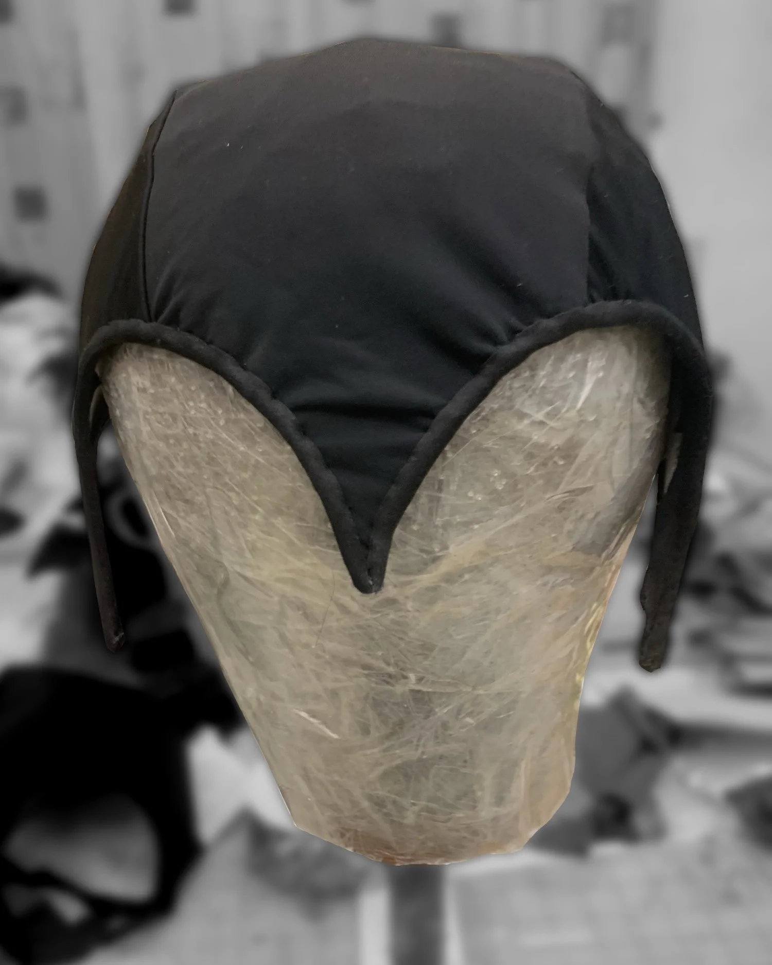 Pattern created using draping technique and machine used to sew three pieces of buckram shaped with steam
