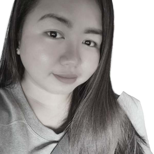 A grayscale close-up photo of a young woman with long hair, smiling softly at the camera, wearing a casual shirt.