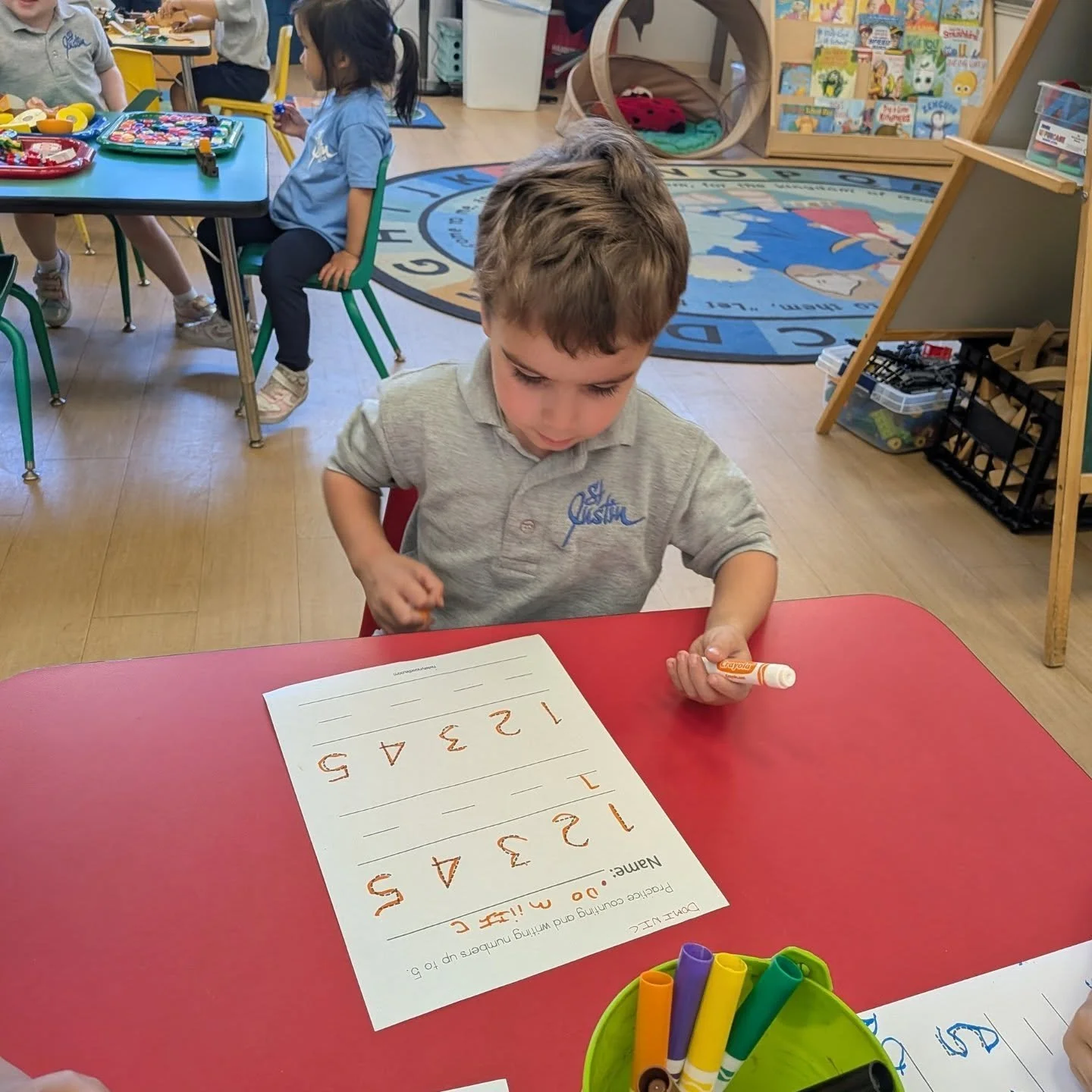 Our St. Justin 3-year-old preschool students are getting ready for our 4-year-old PreKindergarten class as they build the skills they need for Kindergarten! 🎉📚✏️ 

Our little learners have been busy with centers in action: 🔢 Writing numbers, count