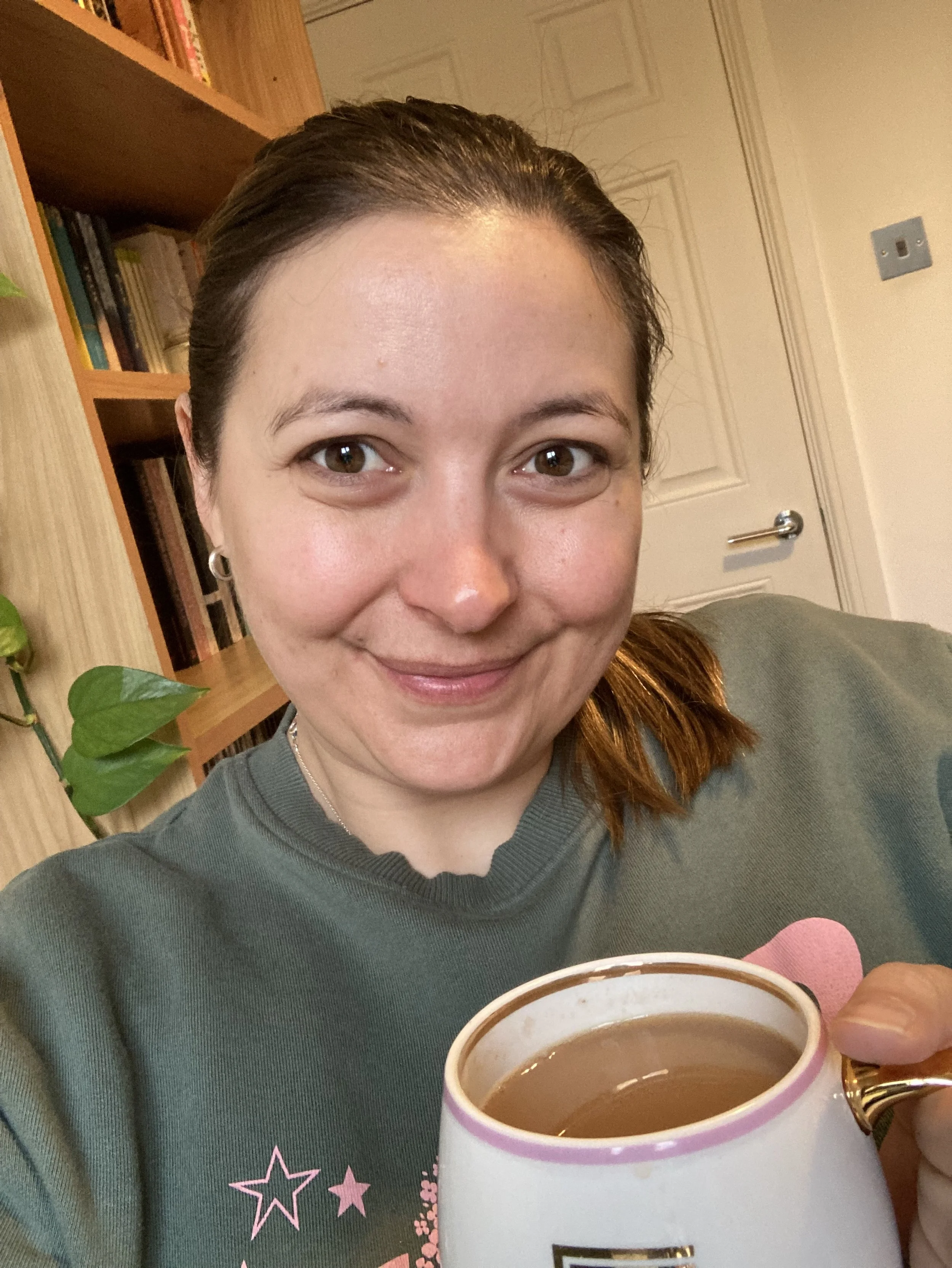 Emily with tea welcoming you to sit down and take some time to do the toolkit to empower you to feel better rested