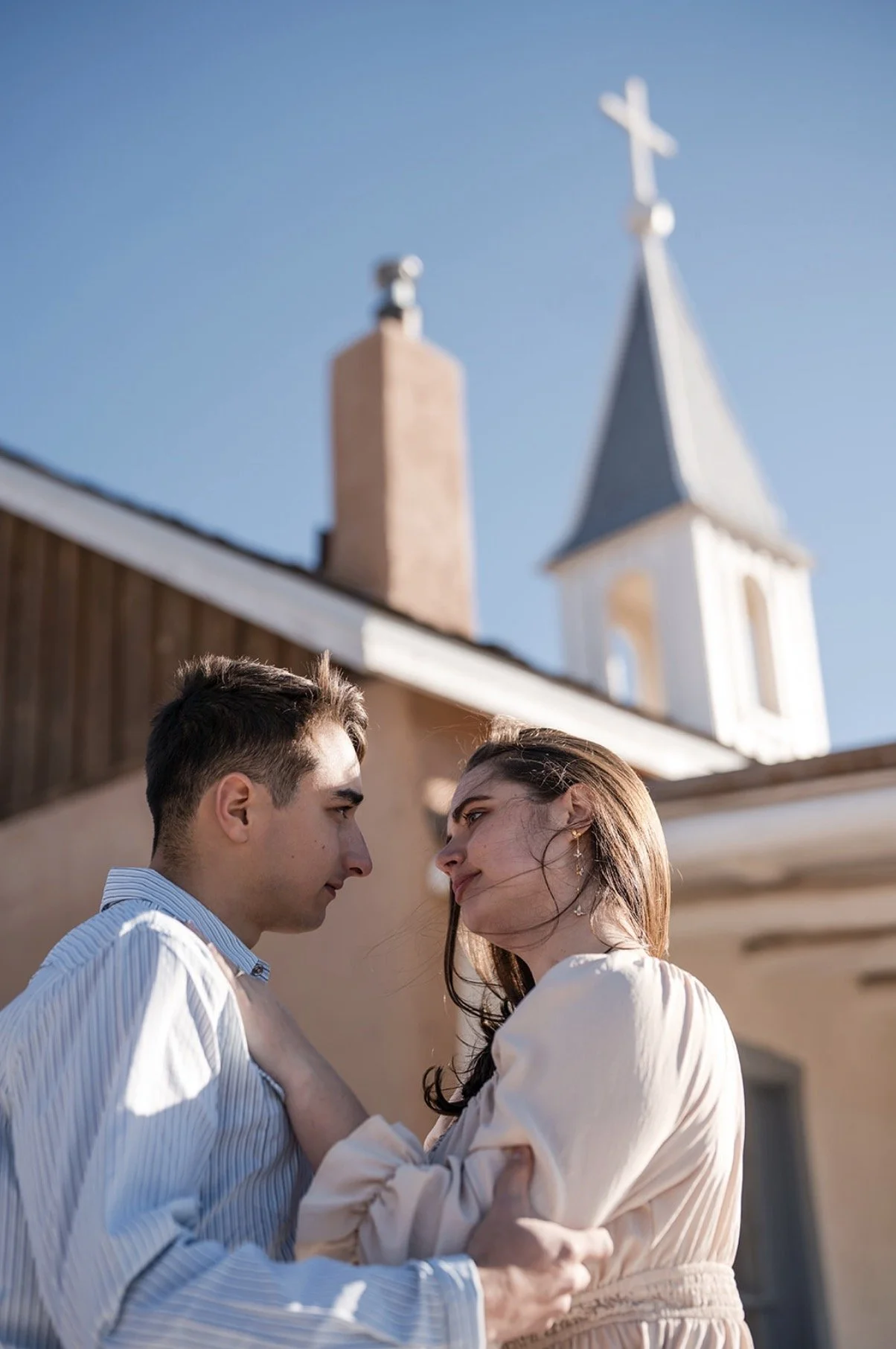 couple portrait Bishop's Lodge historic chapel steeple Santa Fe engagement photographe