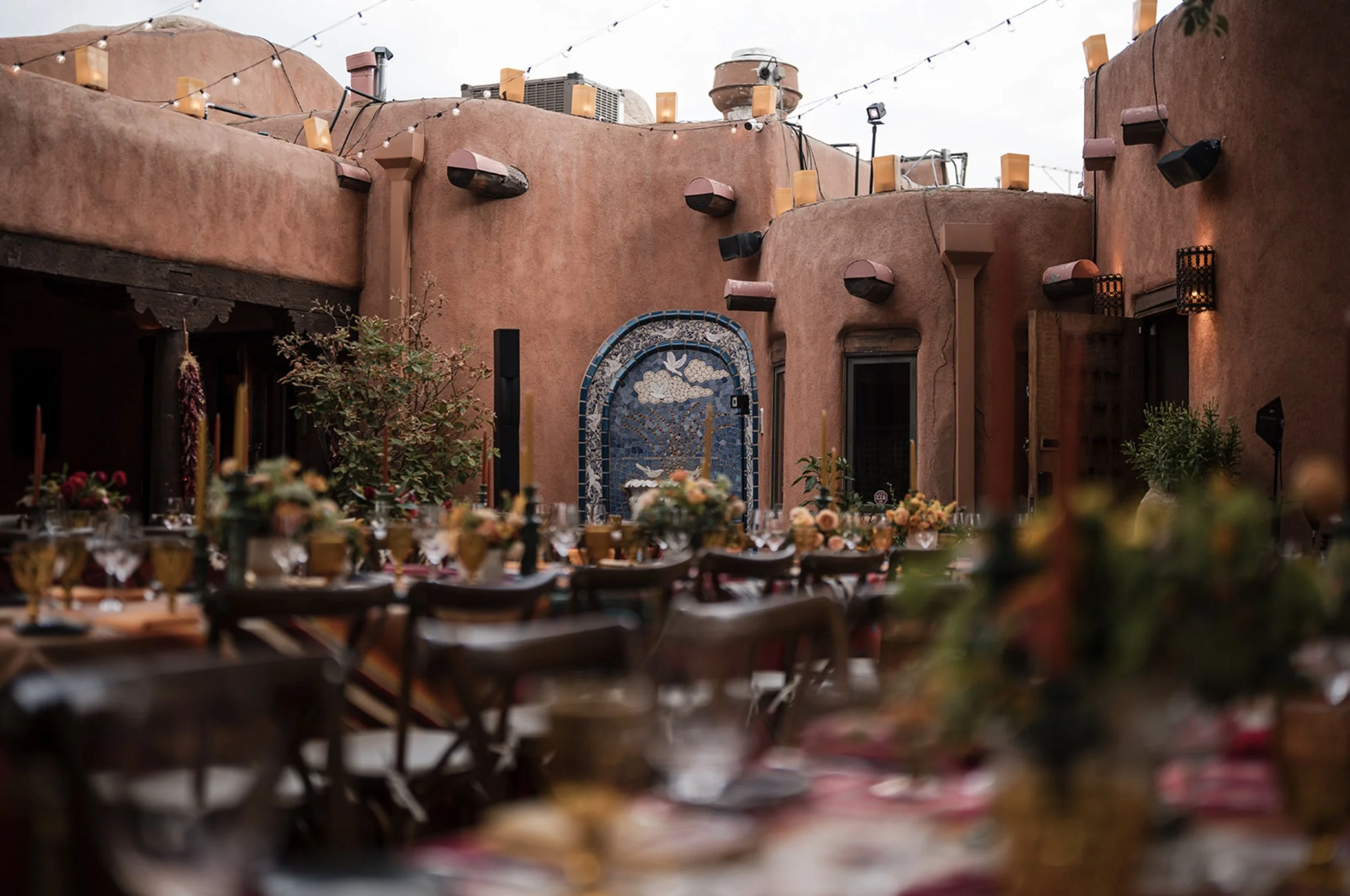 private dinner Pink Adobe Santa Fe courtyard adobe walls mosaic fountain luminarias event photographer Casey Addaso