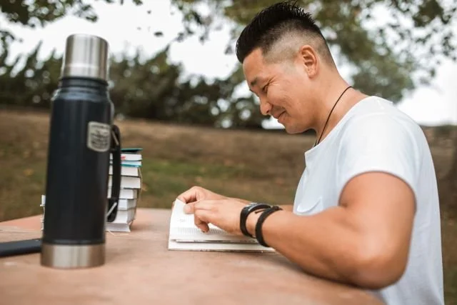 Asian American male reading representing a therapist in Portland, Oregon providing therapy for depression, anxiety, identity, and relationships for Asian Americans in Oregon and California.