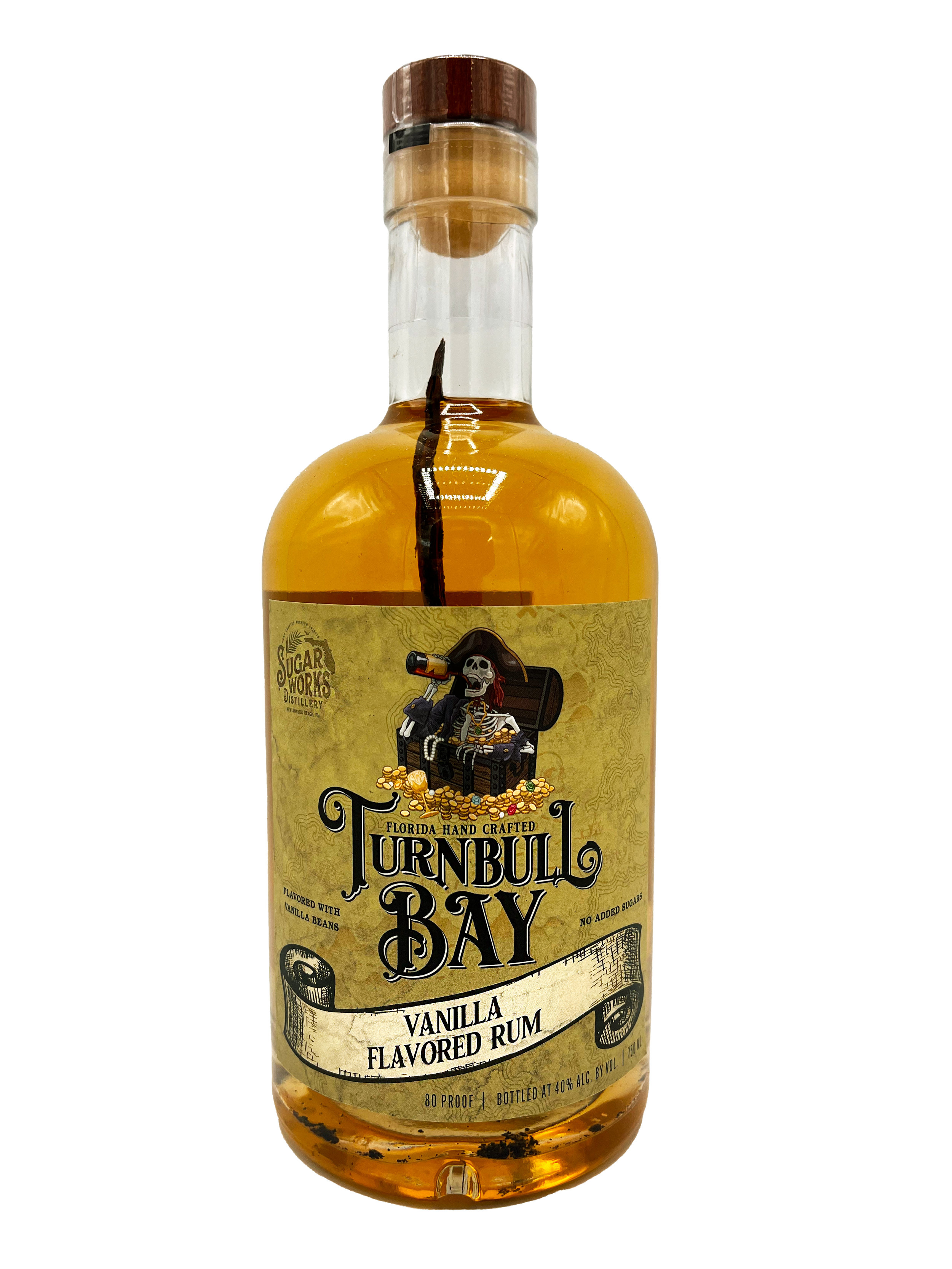 A bottle of Turnbull Bay vanilla flavored rum produced by Sugar Works Distillery, with a black and gold label, showing a skeleton pirate sitting in a treasure chest, surrounded by gold coins, with a black sealed cap and a vanilla bean inside.
