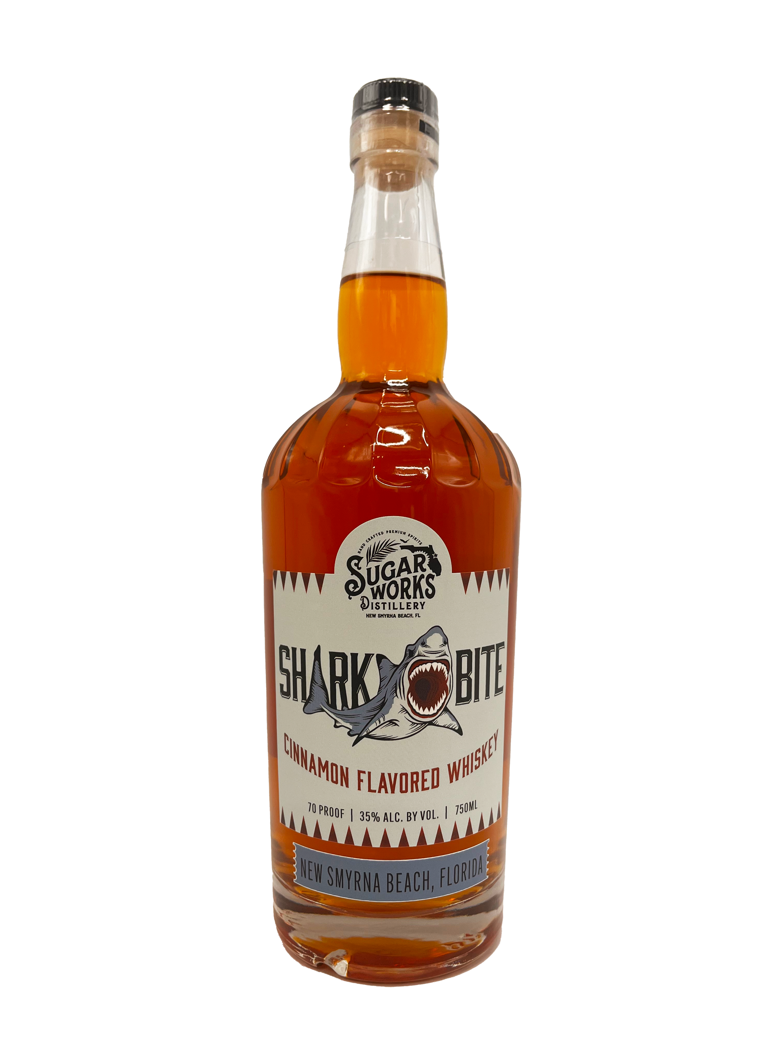 Bottle of cinnamon flavored whiskey branded 'Sharkbite' from Sugar Works Distillery in New Smyrna Beach, Florida, with a cartoon shark on the label.