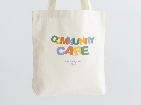 Community Care Whtie Tote Product Photo Close-Up.PNG
