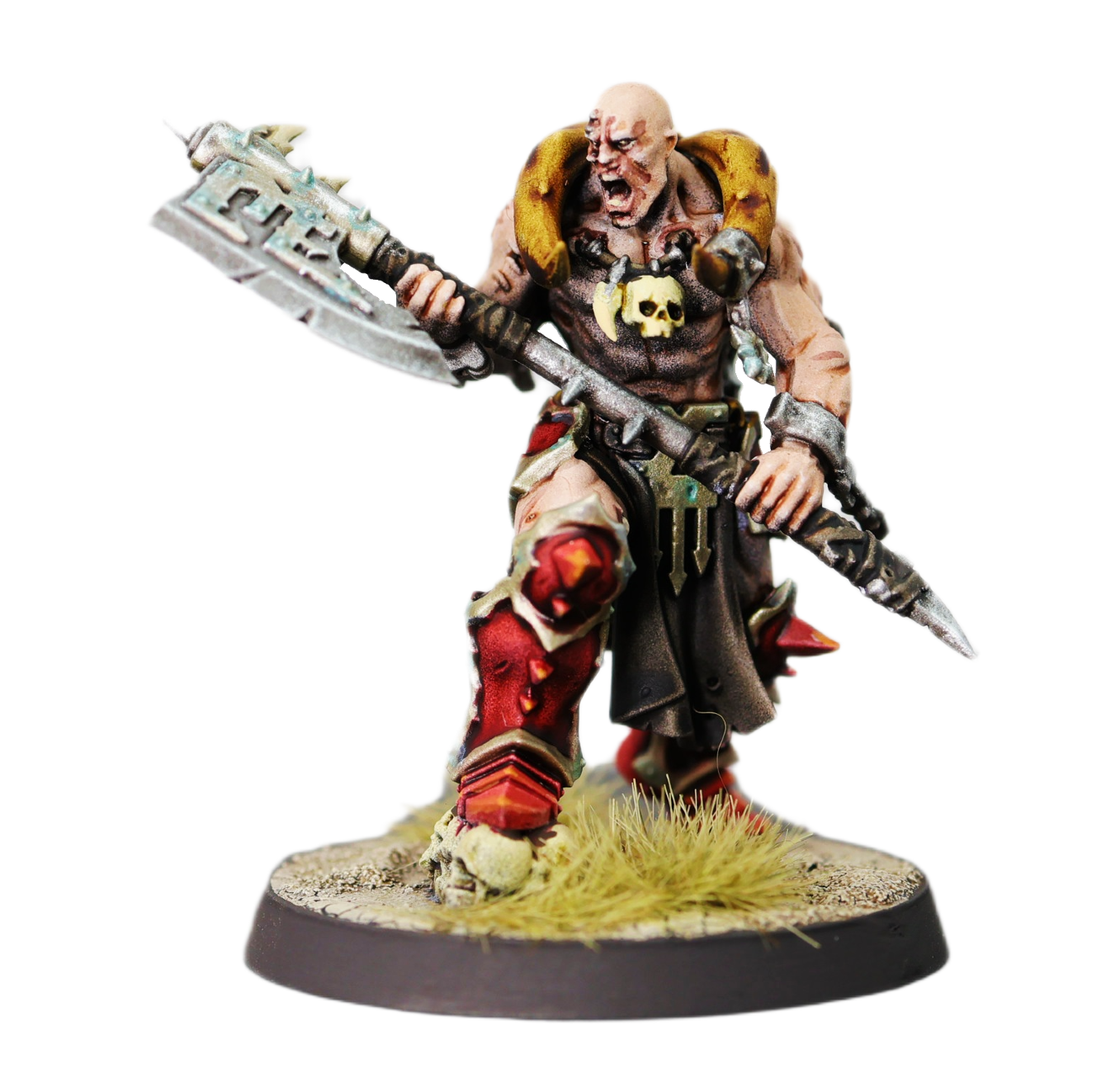 Miniature fantasy warrior figurine holding a large weapon, dressed in rugged armor with skull motifs and red clothing, standing on a decorated base with grass and rocky terrain.